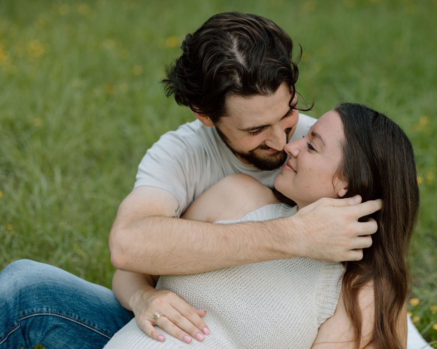 Tender romantic moment between a couple sharing an embrace outdoors.