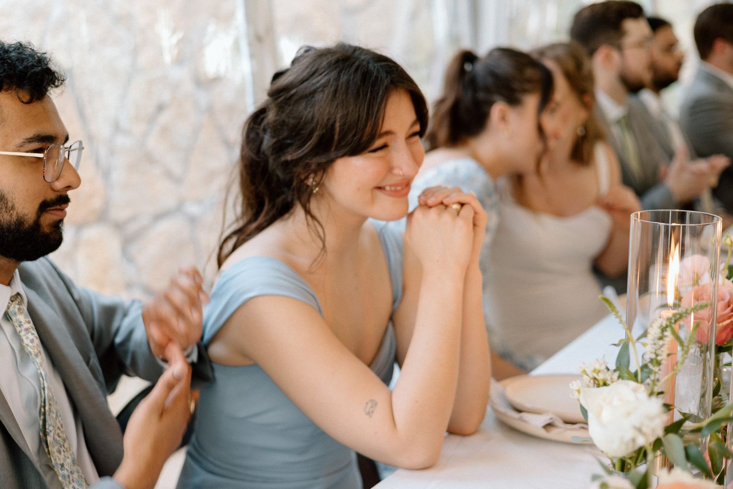 Wedding guests enjoying dinner at an elegantly decorated reception table.