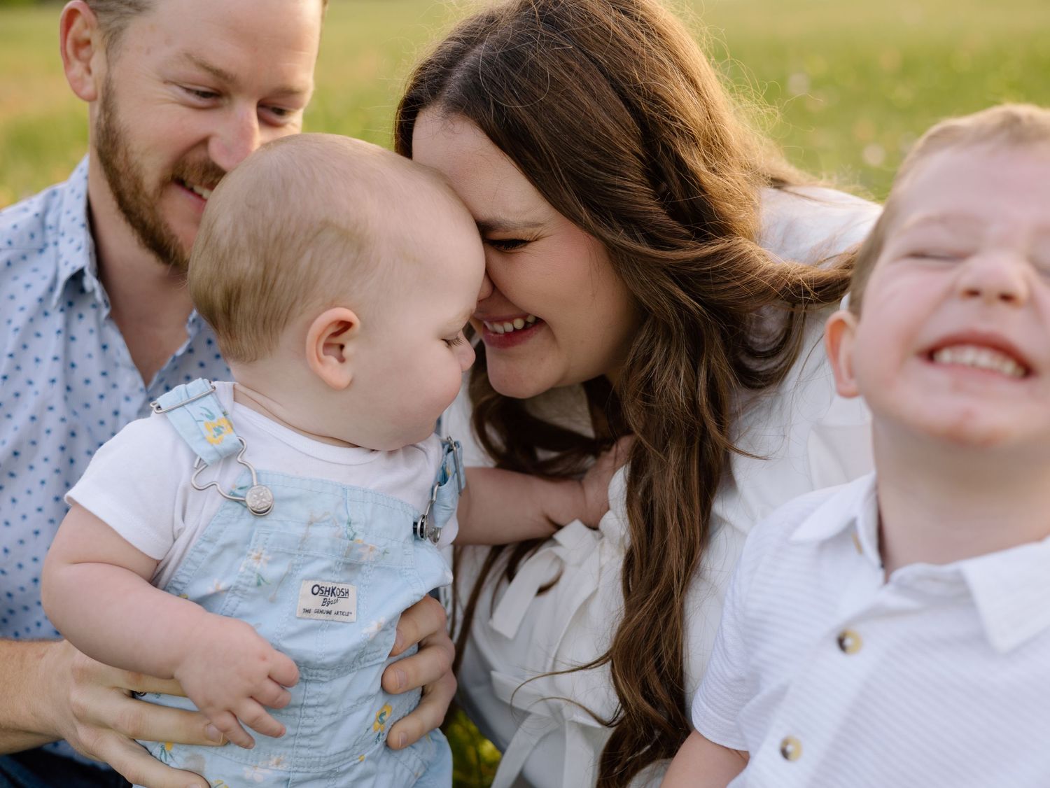 A happy family shares joyful moments together outdoors on a sunny afternoon.