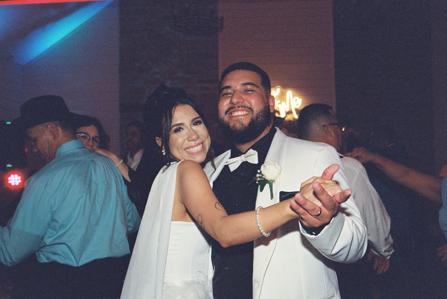 A happy couple shares a dance together at their wedding reception.