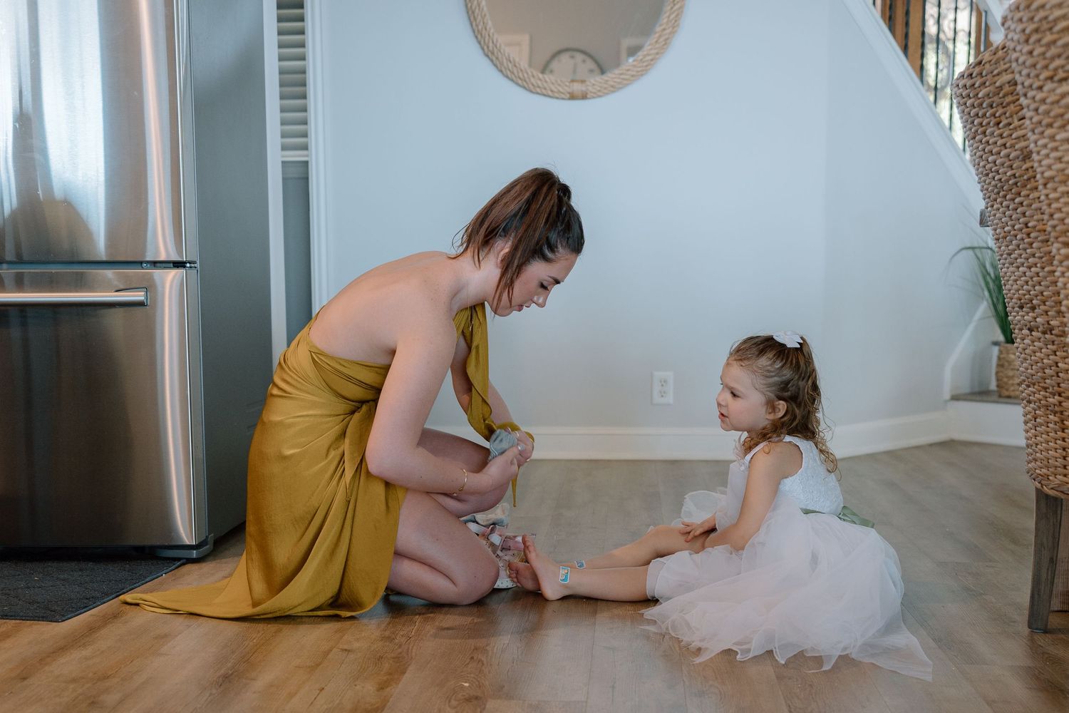 A touching moment of getting ready between two people in a bright modern kitchen.