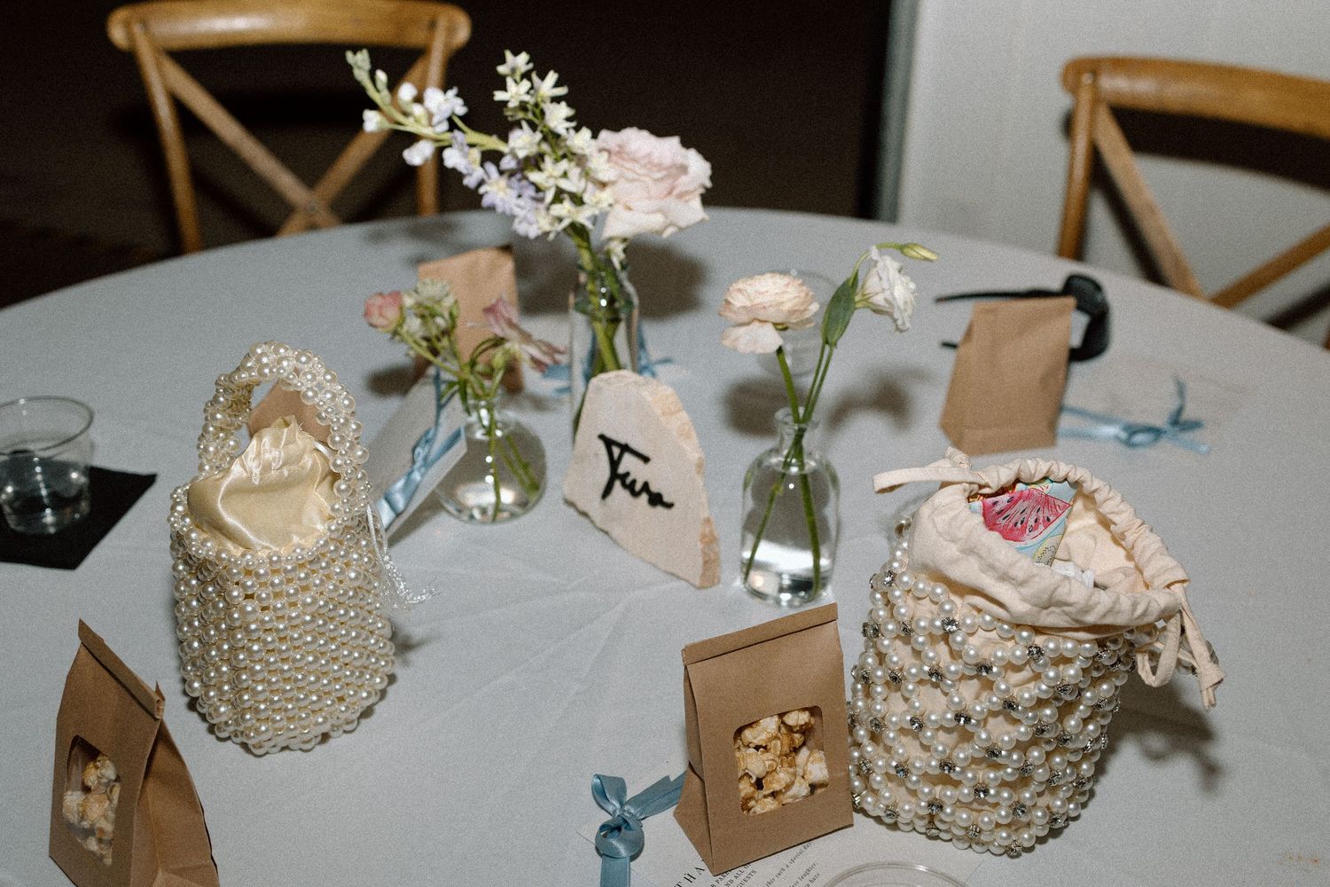 Wedding reception table decor with macrame centerpieces and delicate floral arrangements.