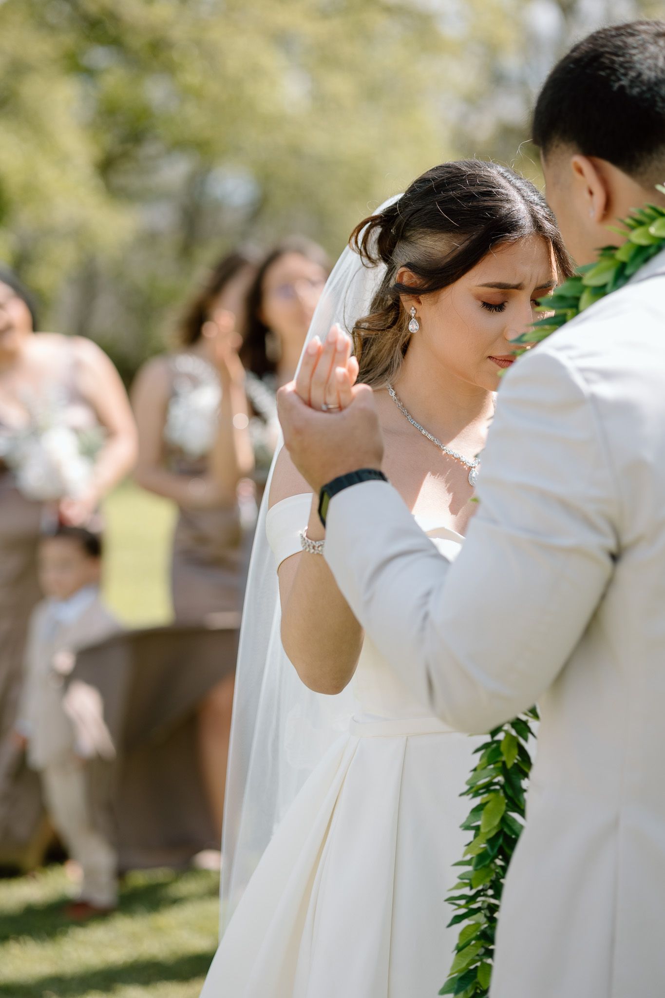 A tender moment during an outdoor wedding ceremony as a couple shares their first dance on a sunny day.