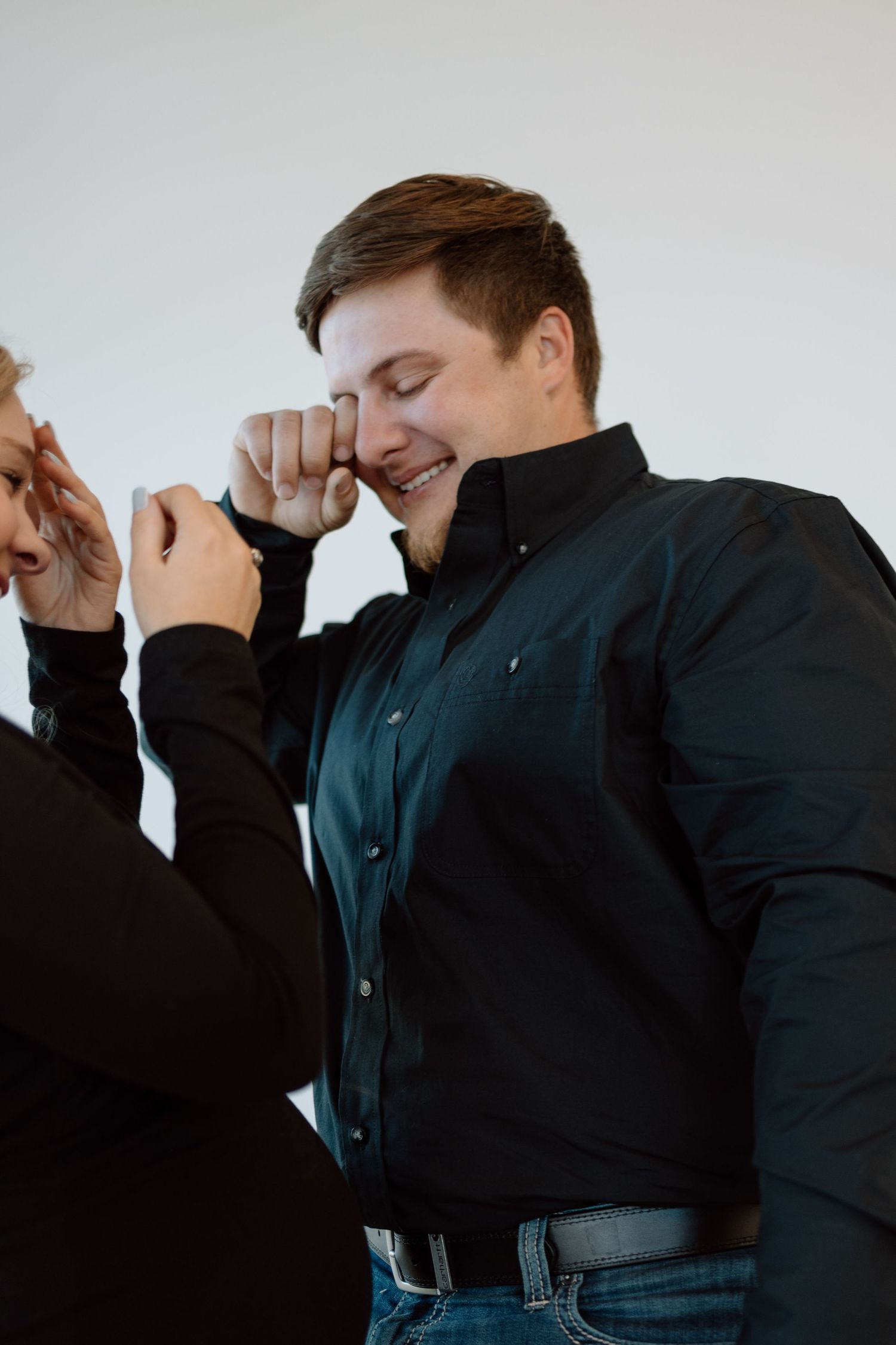 Two people sharing a joyful candid moment together while laughing and being playful.