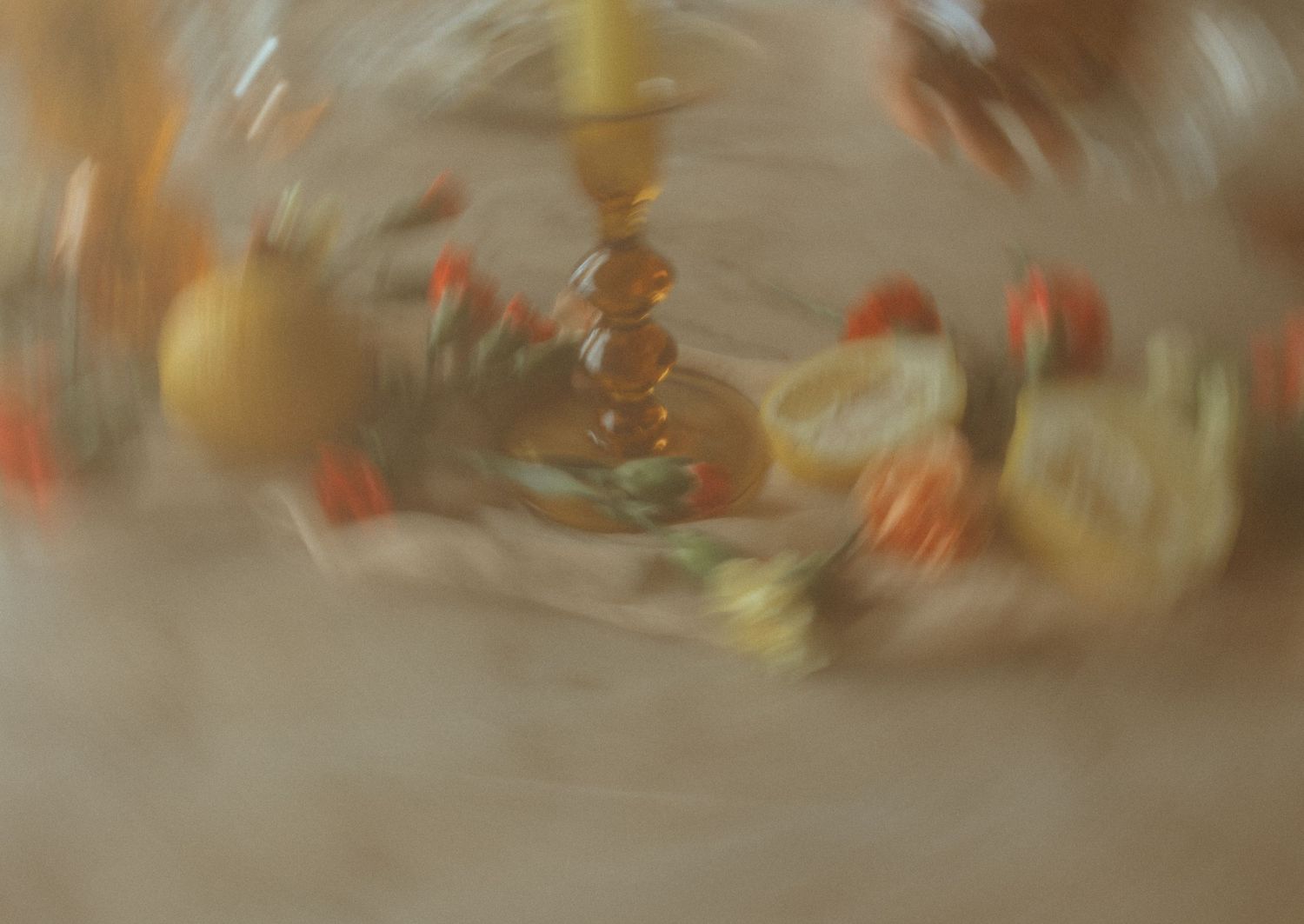 Blurred artistic still life with orange and yellow tones featuring decorative items.