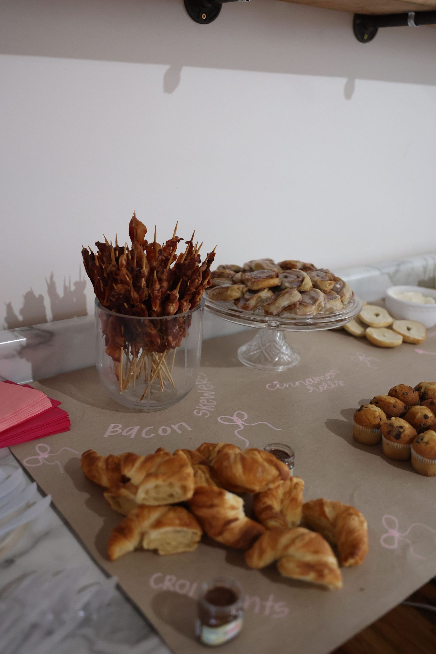Buffet table with assorted pastries and snacks laid out on kraft paper.