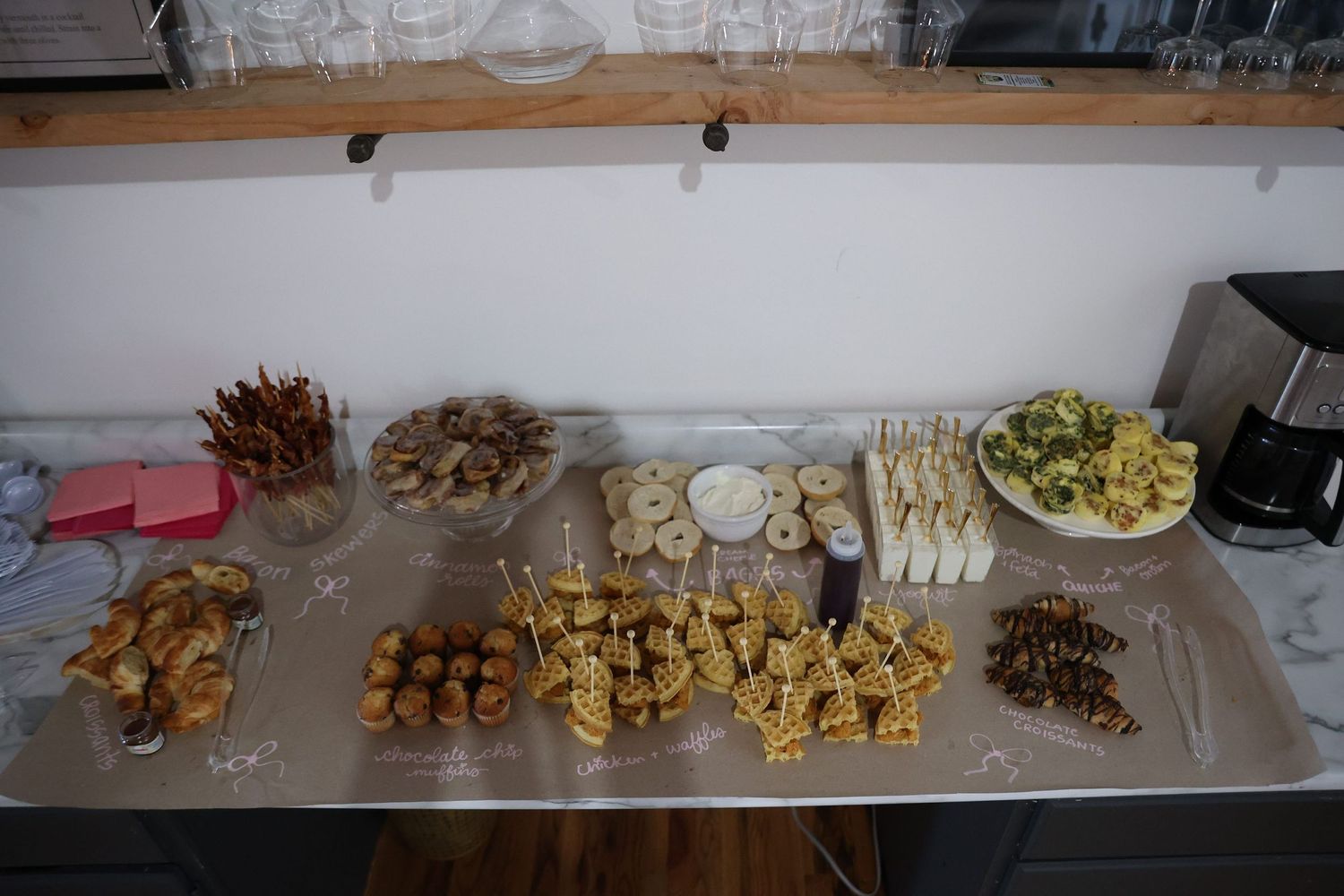 Overhead view of catering display with various appetizers and snacks arranged on metal counter.