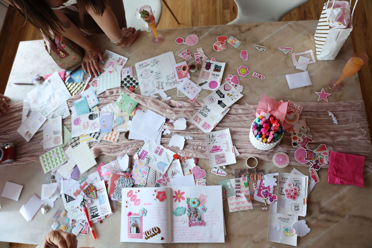 Overhead view of crafting supplies and decorations spread across a table surface.