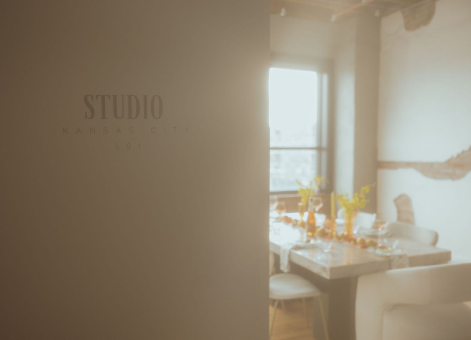 Soft focus interior view of a modern studio space with natural lighting.