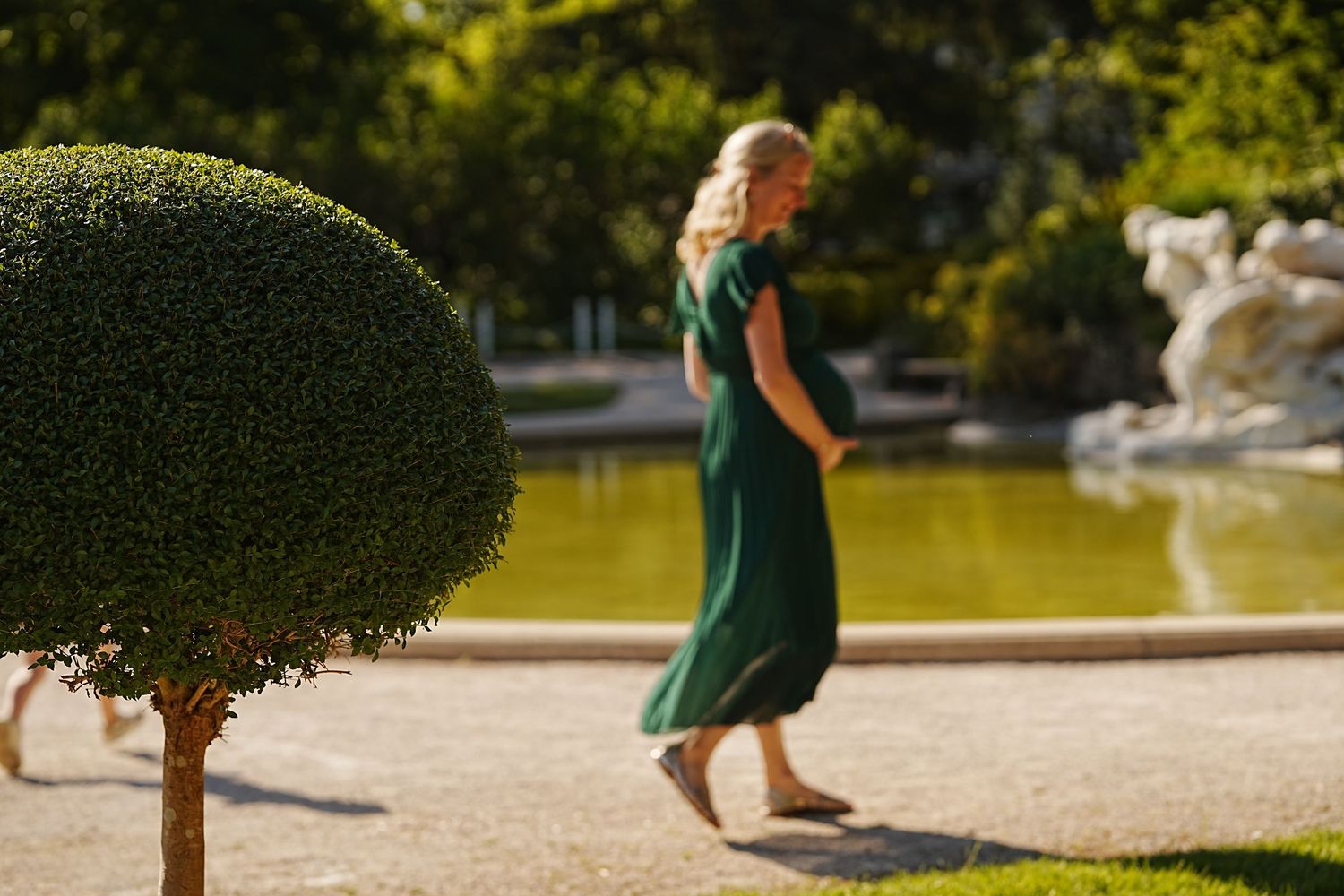Playful sequence showing people dancing and jumping in a sunny garden setting.