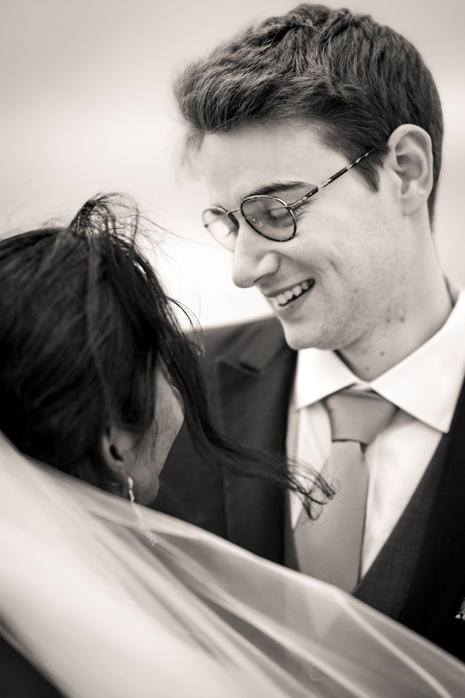 Series of intimate black and white wedding portraits showing joyful expressions.