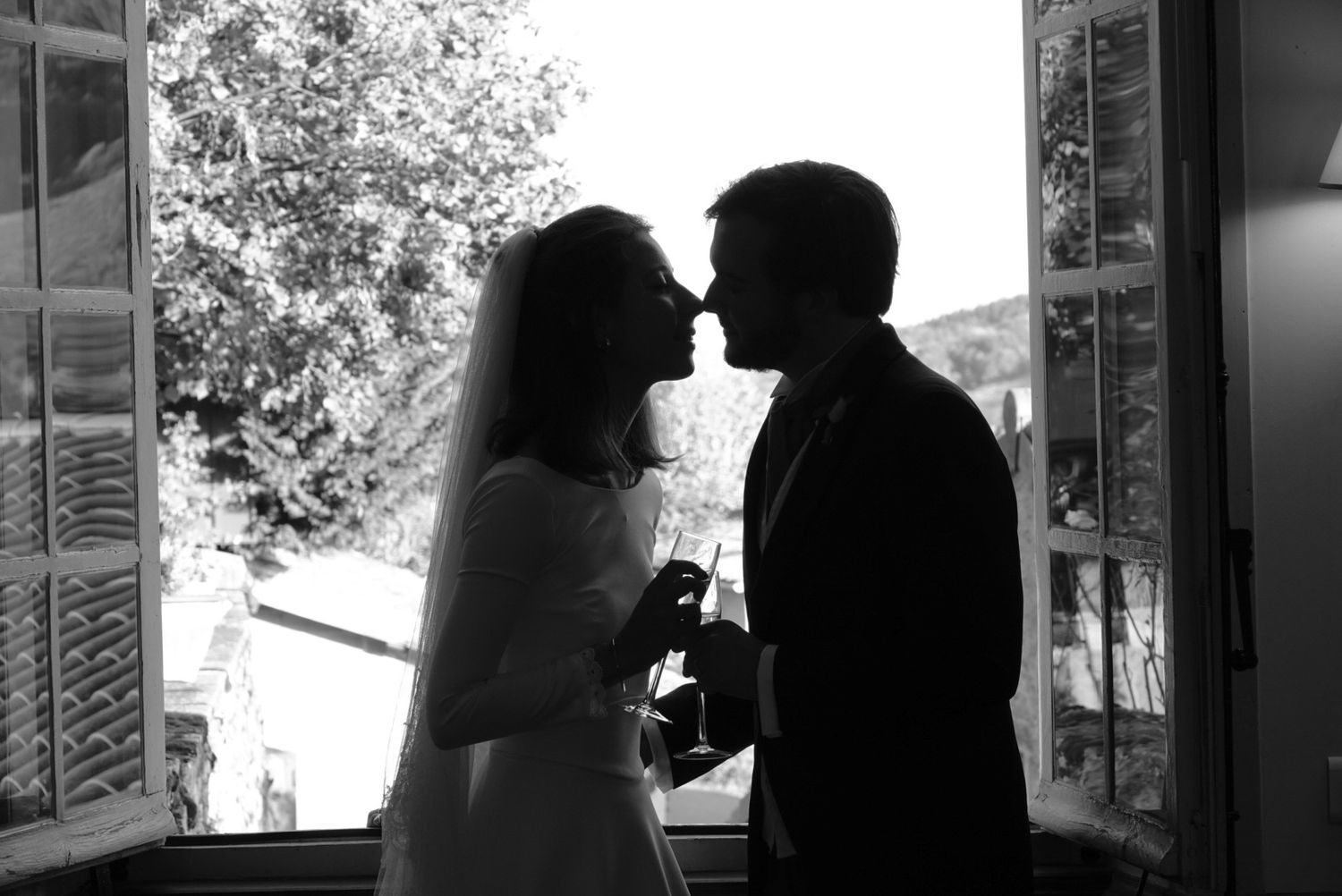 A black and white photo montage shows silhouettes of people in various poses against bright windows and doorways.