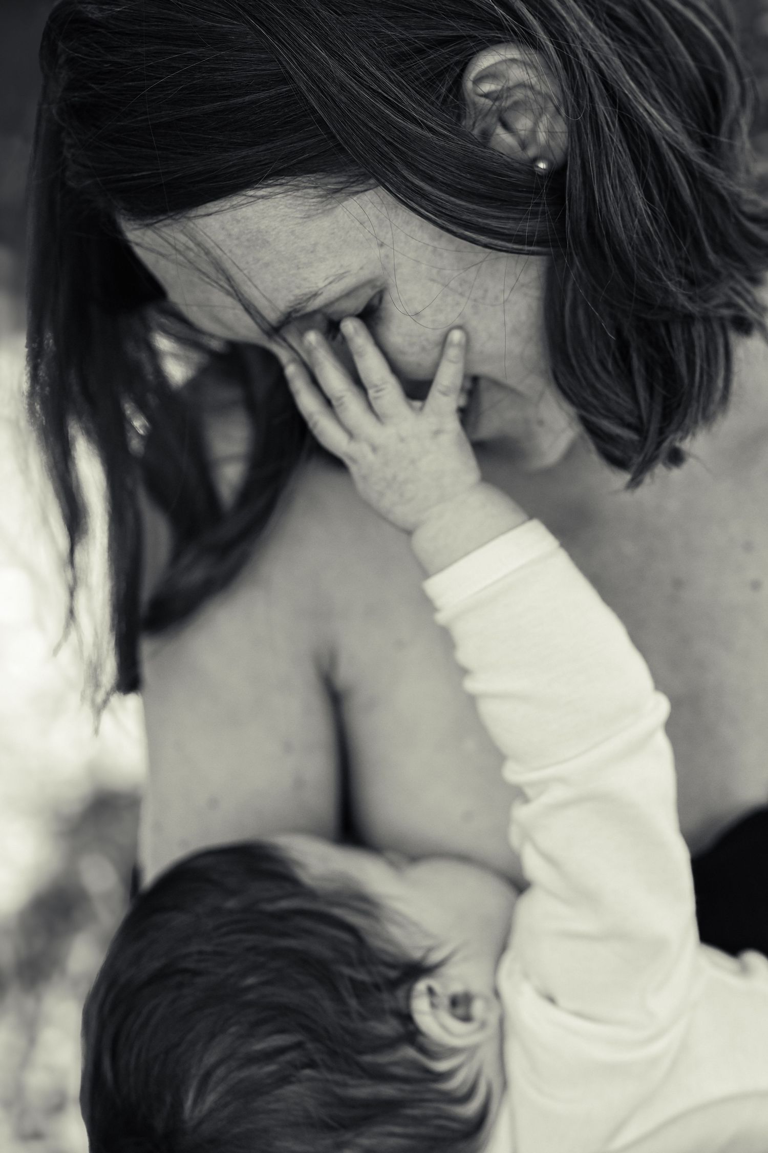 Intimate black and white portrait of tender moment between parent and child.