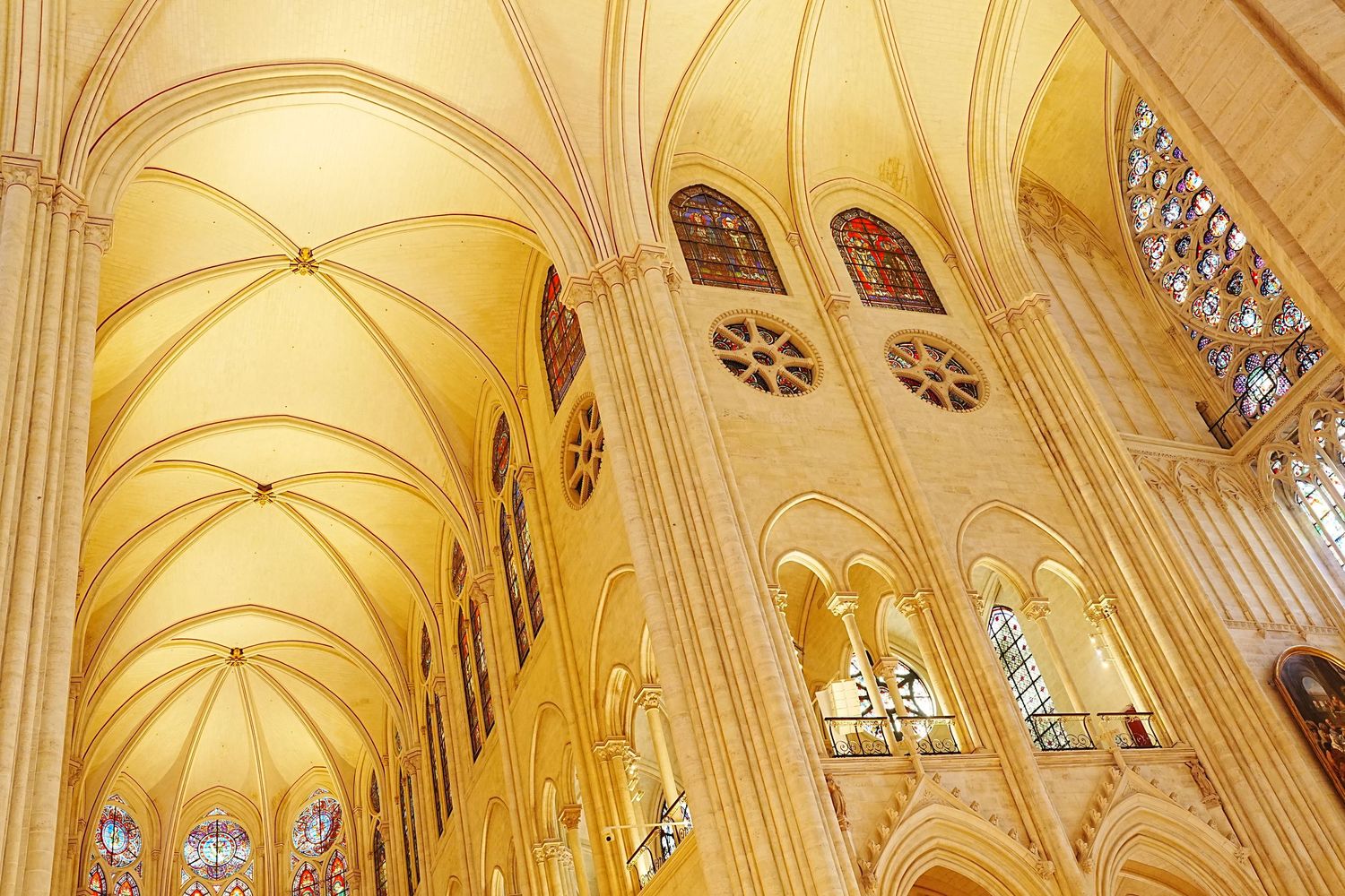 Gothic cathedral interior with vaulted ceiling and ornate architectural details.