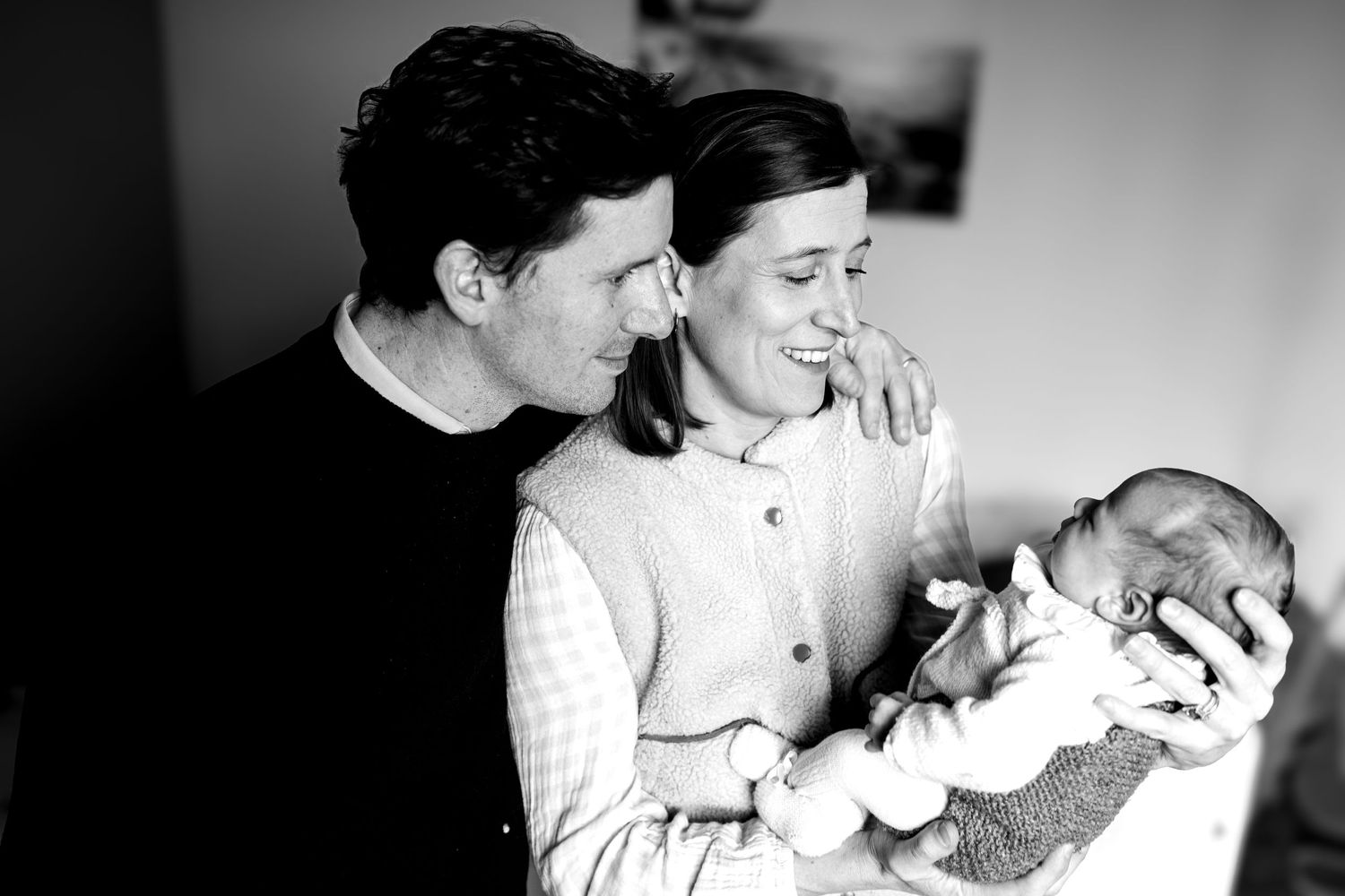 Black and white portrait series showing tender moments with a baby.
