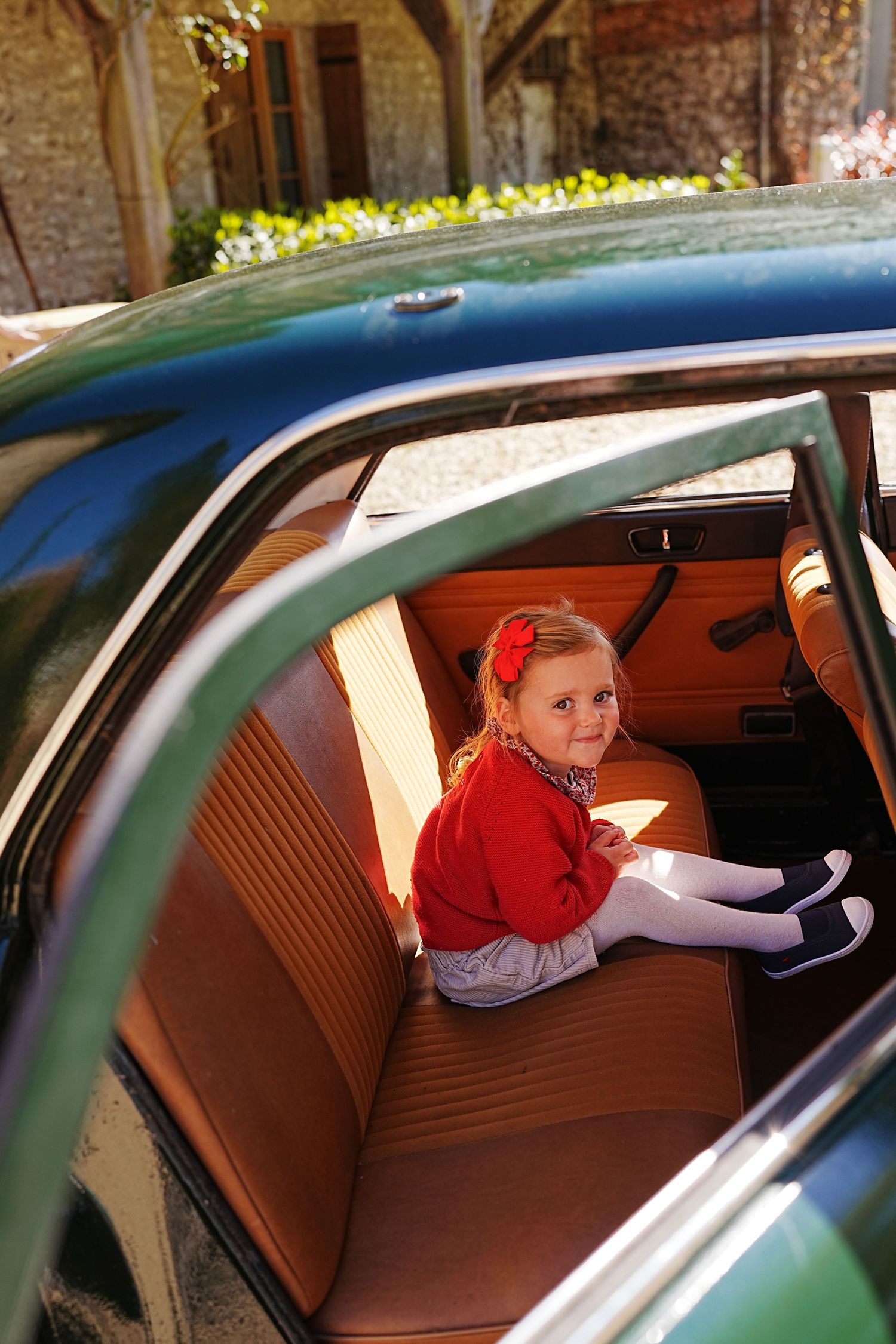 Sequential views inside a classic car with brown leather interior and natural lighting.