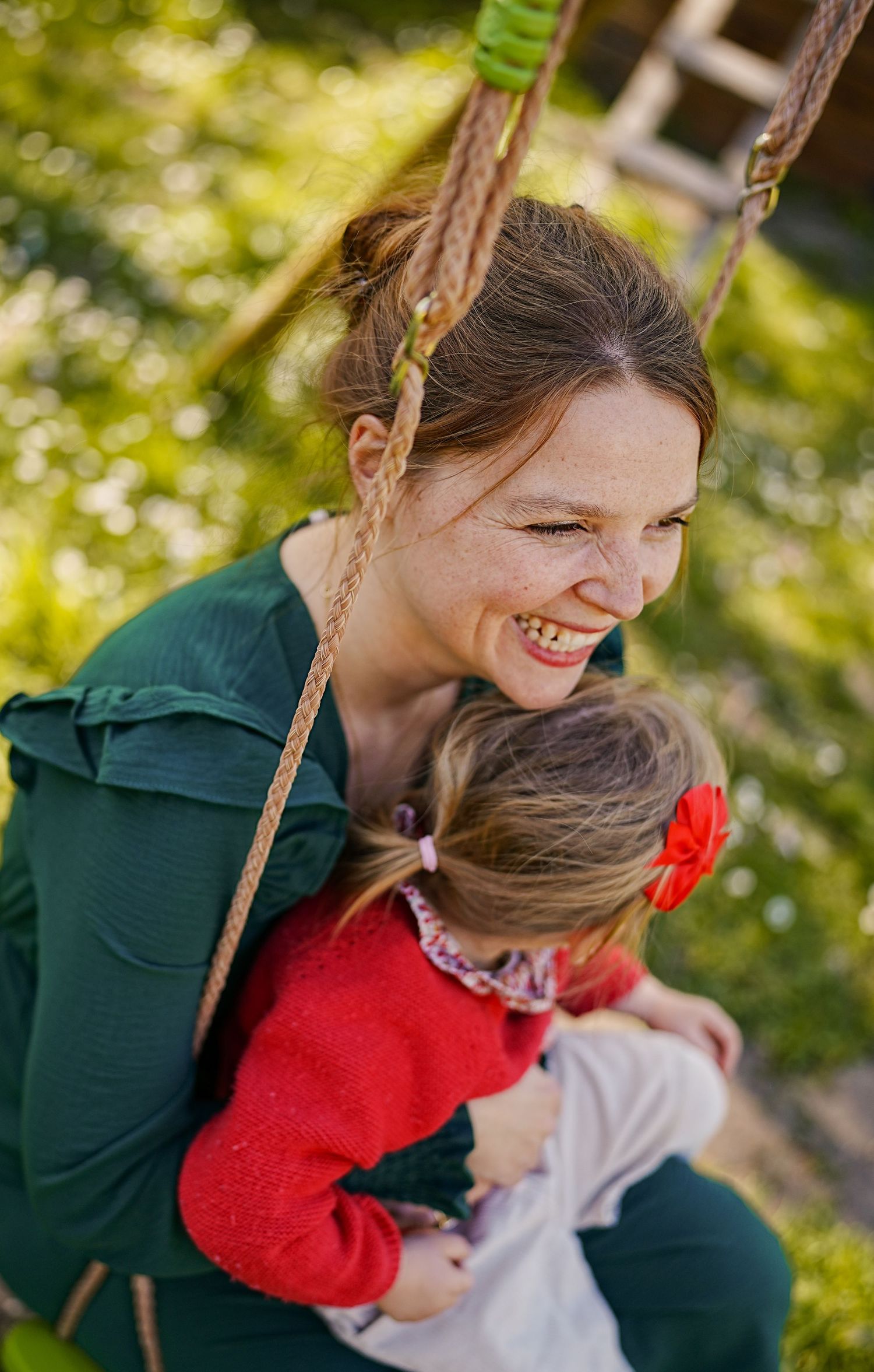 Candid outdoor moment captured in warm sunlight with natural bokeh background.