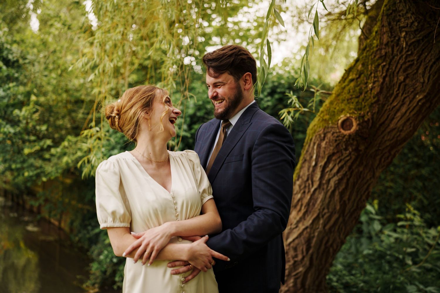 Romantic couple shares intimate moments in a lush garden setting during golden hour.