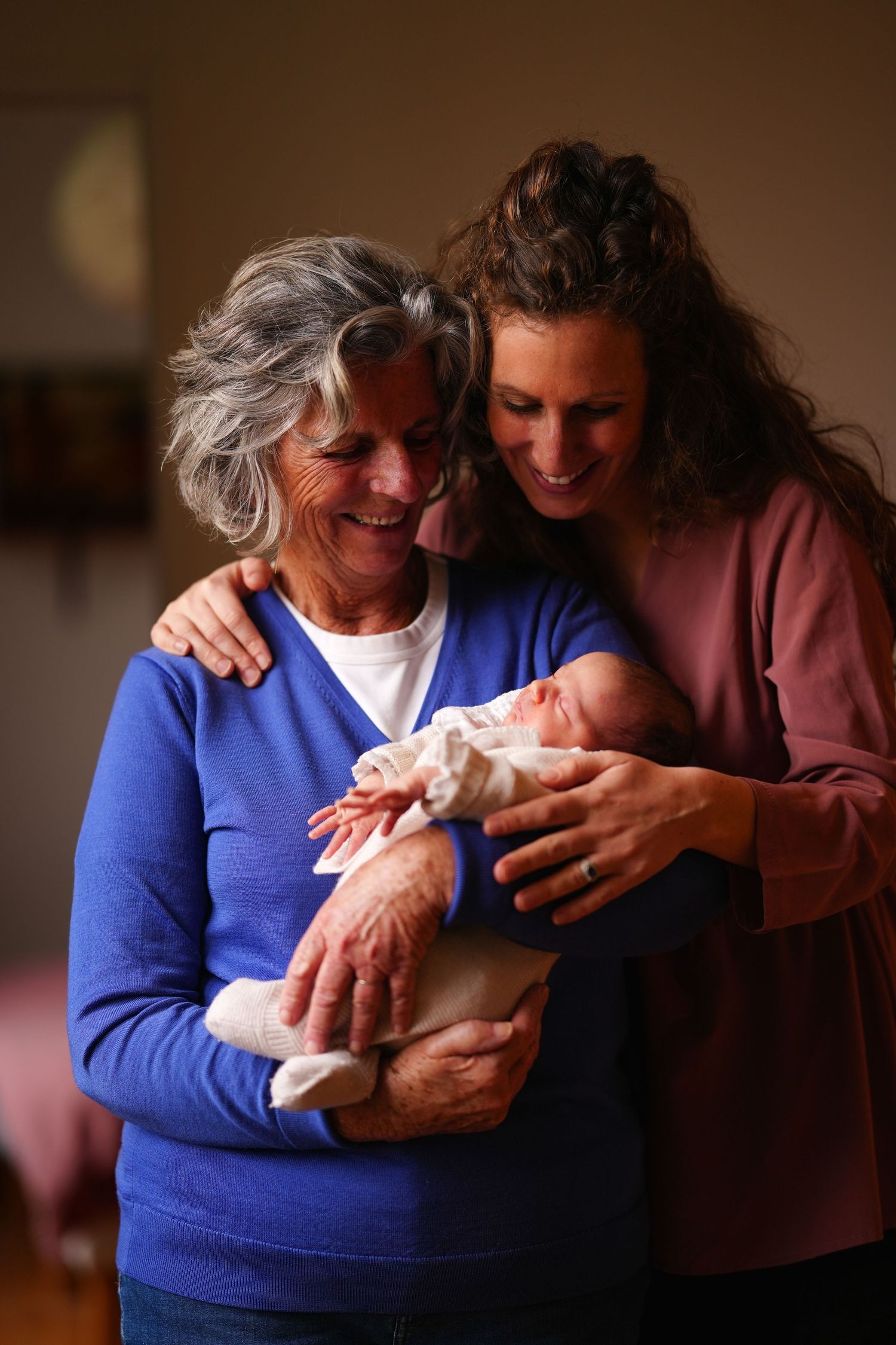 Heartwarming moments of family members holding and admiring a newborn baby.