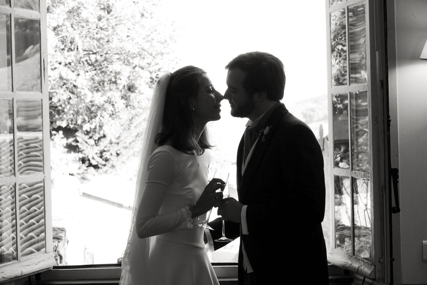Black and white silhouettes of a couple in romantic poses by a window, creating an intimate wedding day montage.