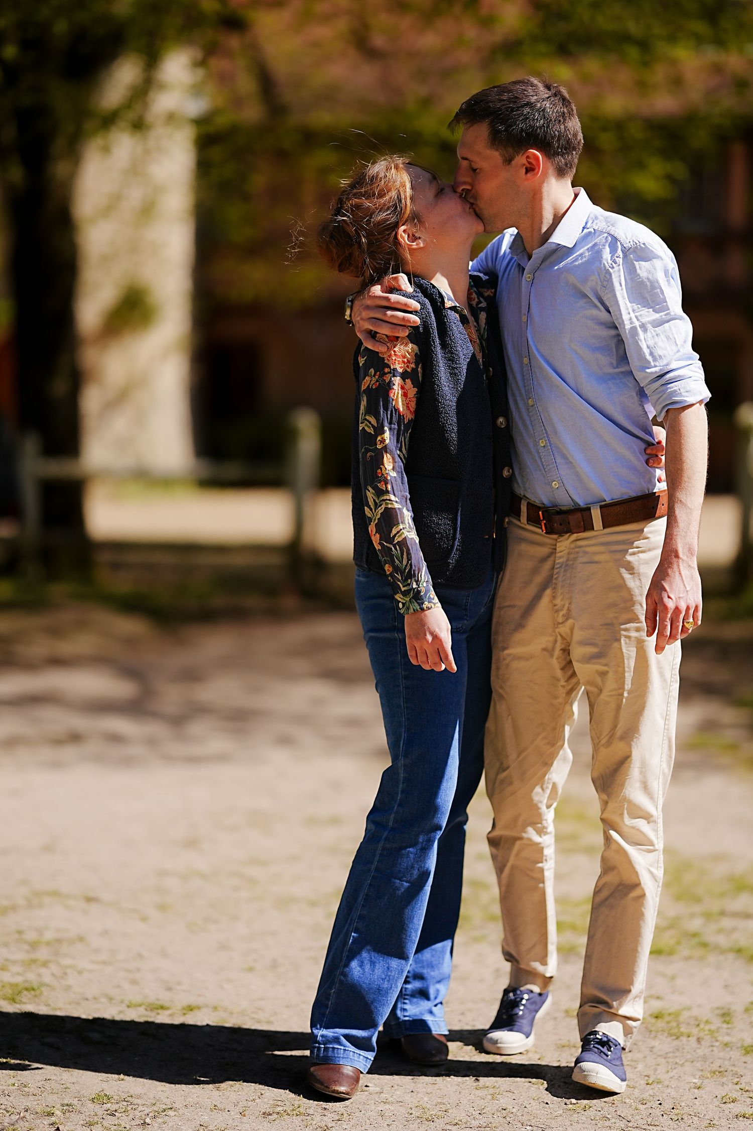 Couple sharing a romantic moment outdoors on a sunny autumn day.