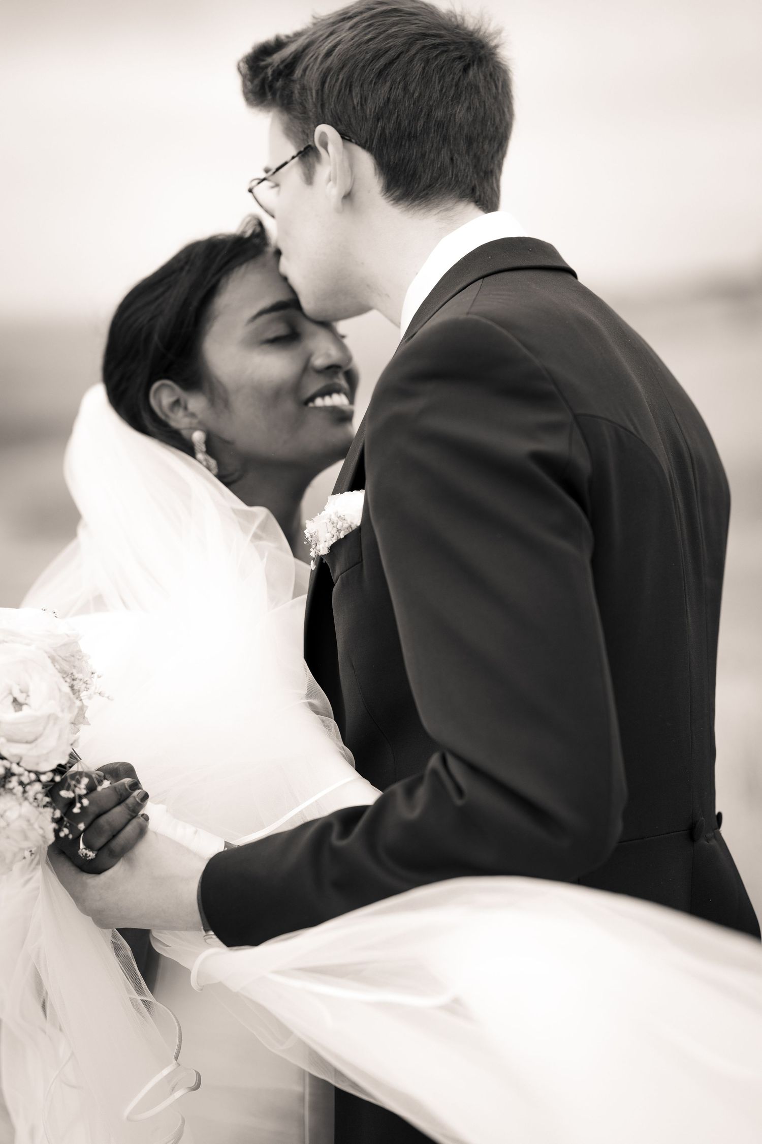 Black and white romantic wedding moment captured in a sequence of intimate poses.