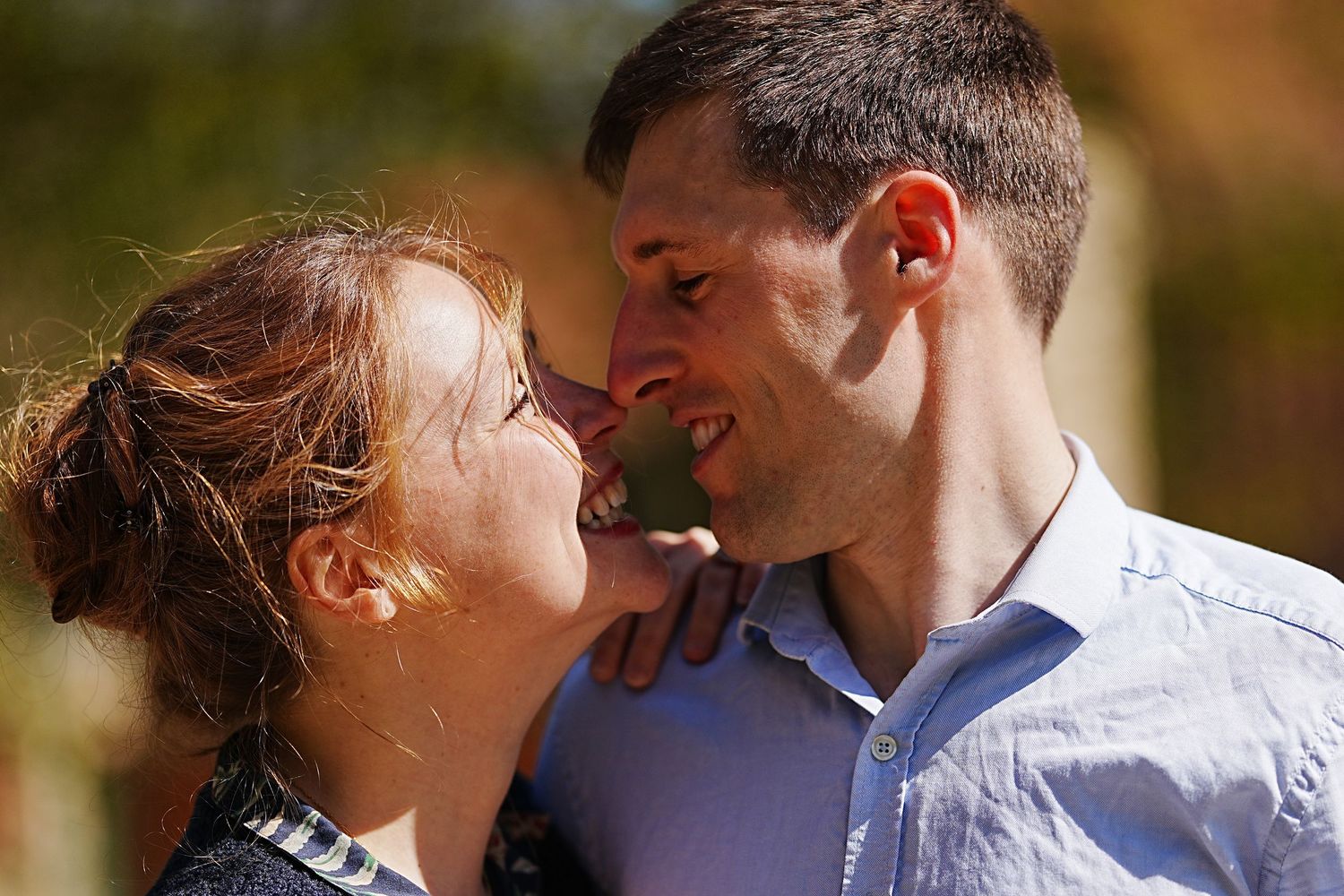 Romantic couple sharing intimate moments in golden outdoor lighting.