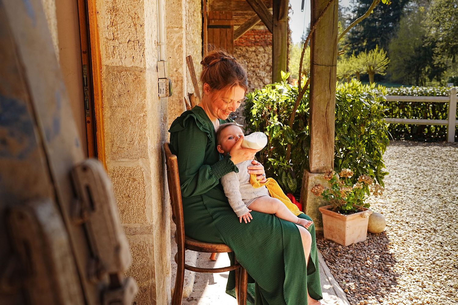 Family members sharing a tender moment near a stone building entrance.