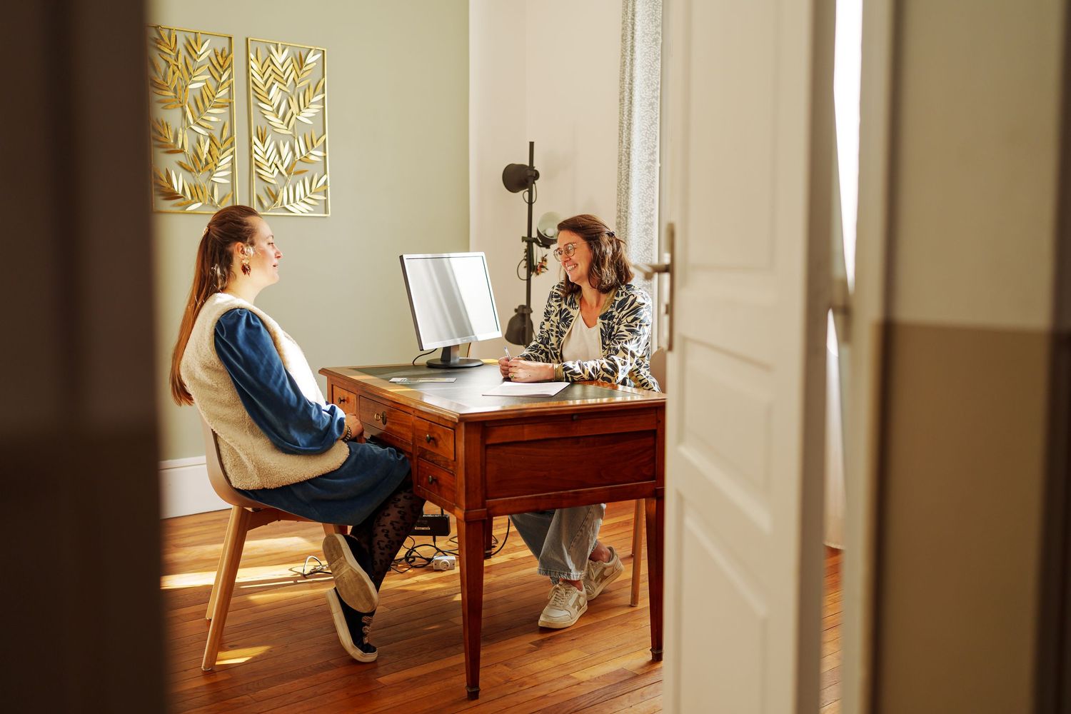 Series of images showing a person sitting at a desk in various poses near a window.