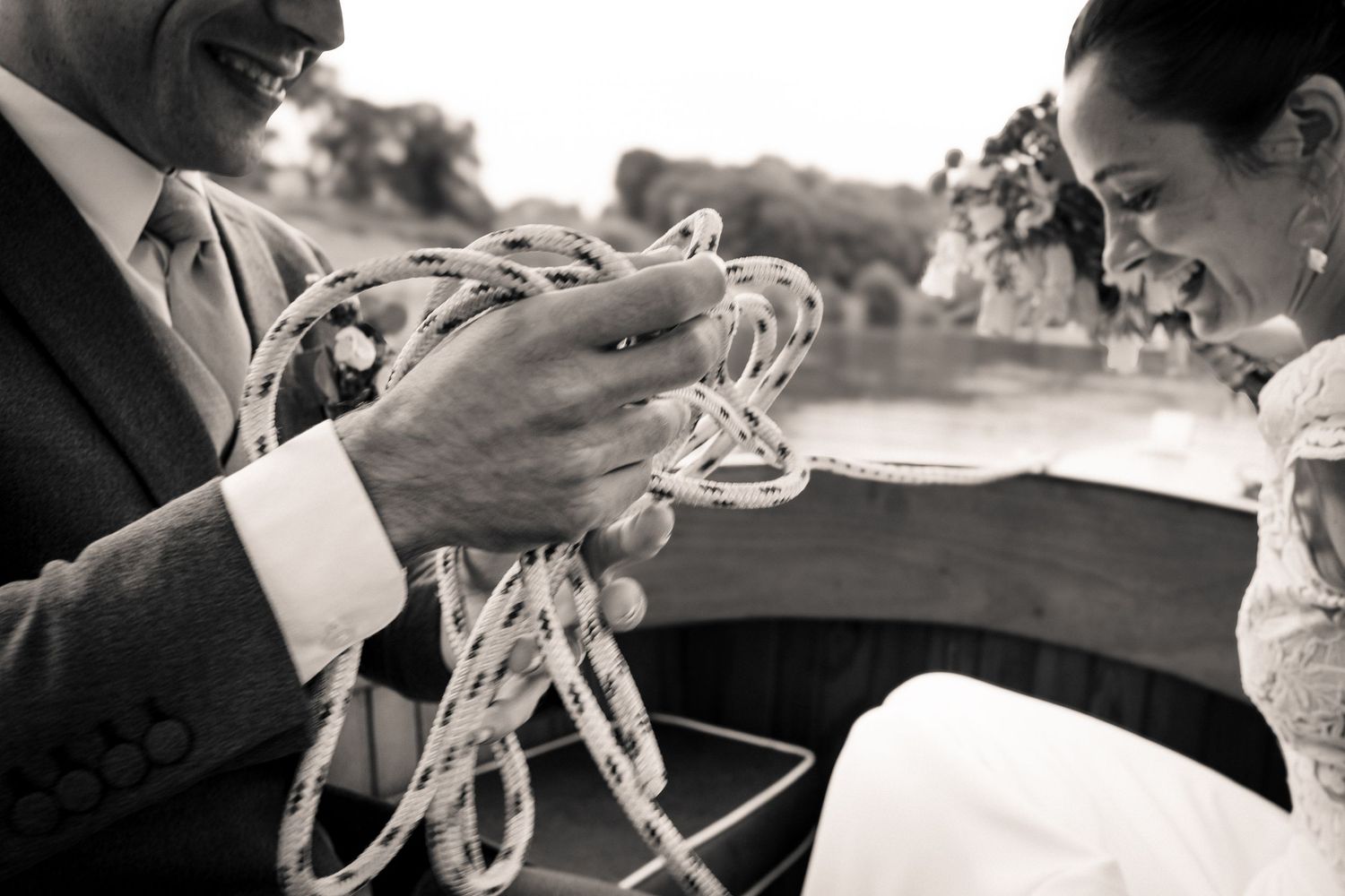 A black and white photo of a couple sharing a romantic moment with champagne glasses.