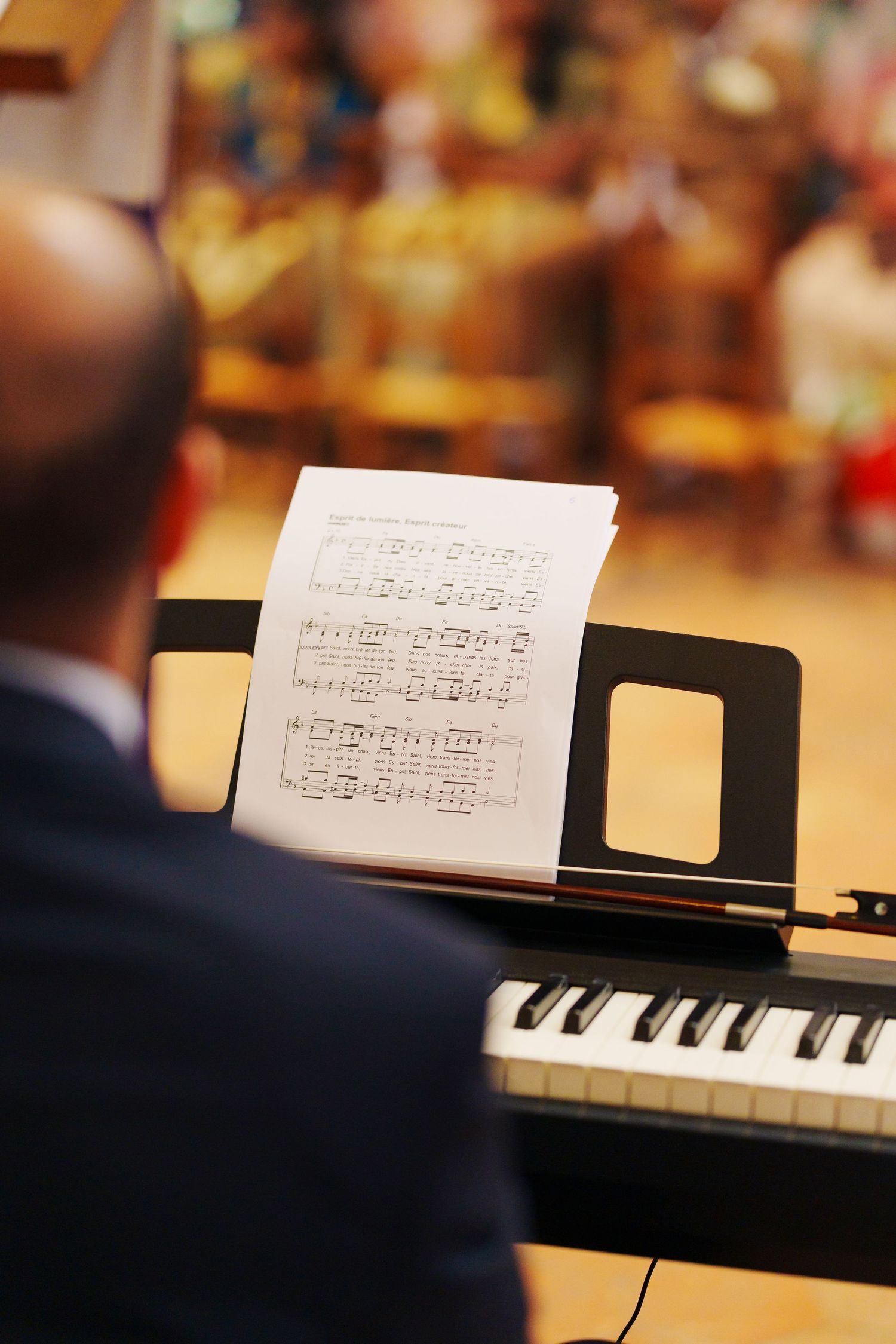 Sheet music displayed on a piano stand with piano keys visible in the foreground.