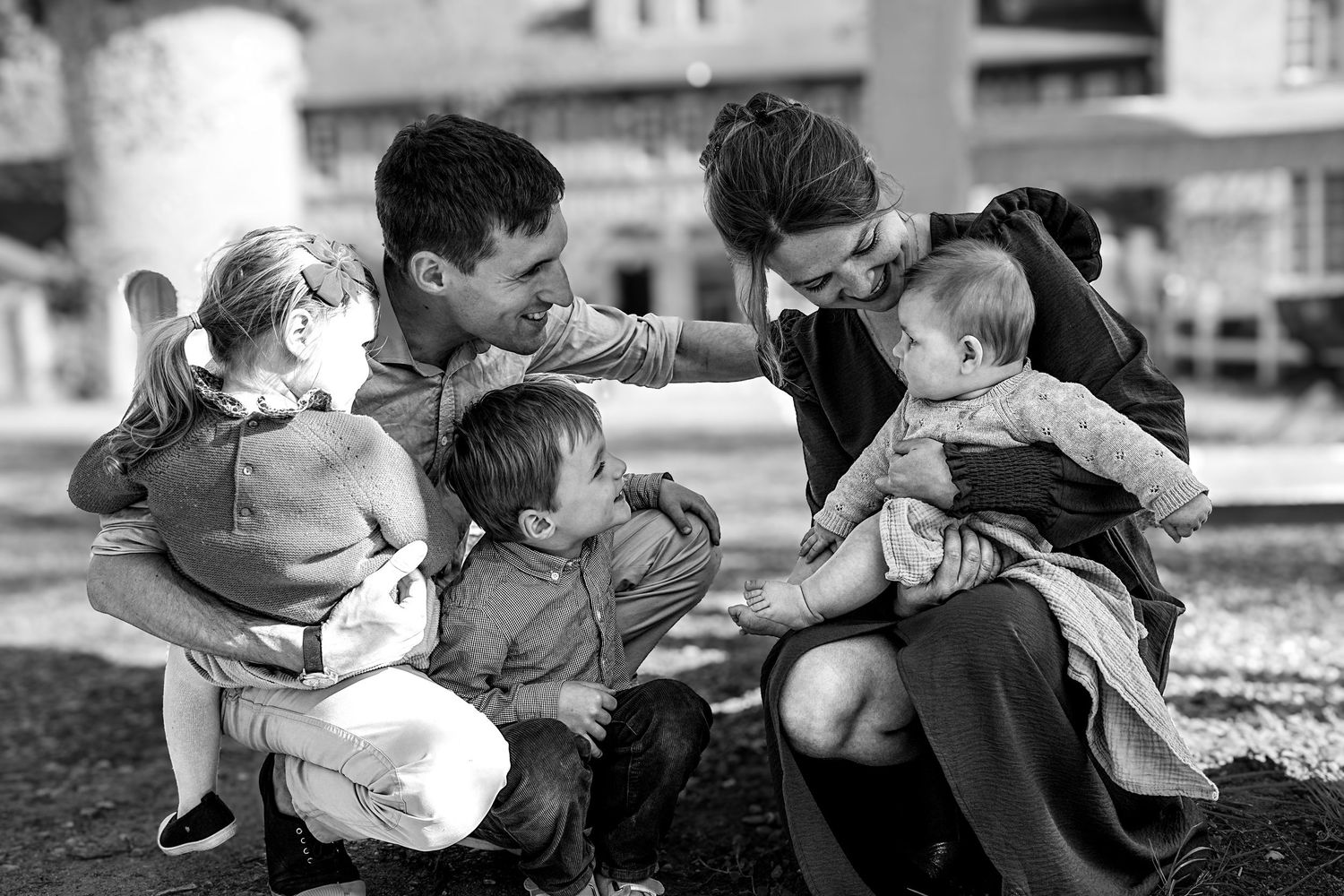 Black and white candid group photo showing close emotional connection.