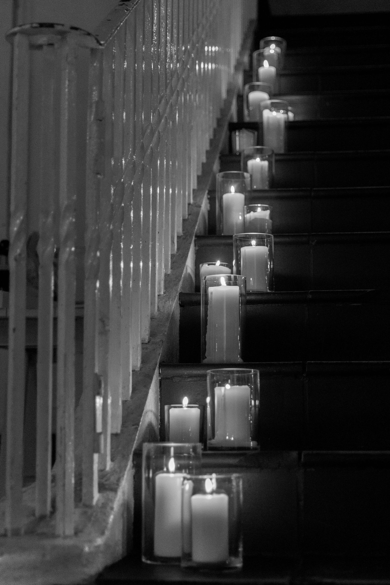 Romantic candlelit staircase decorated with glass-enclosed candles creating an elegant ambiance.