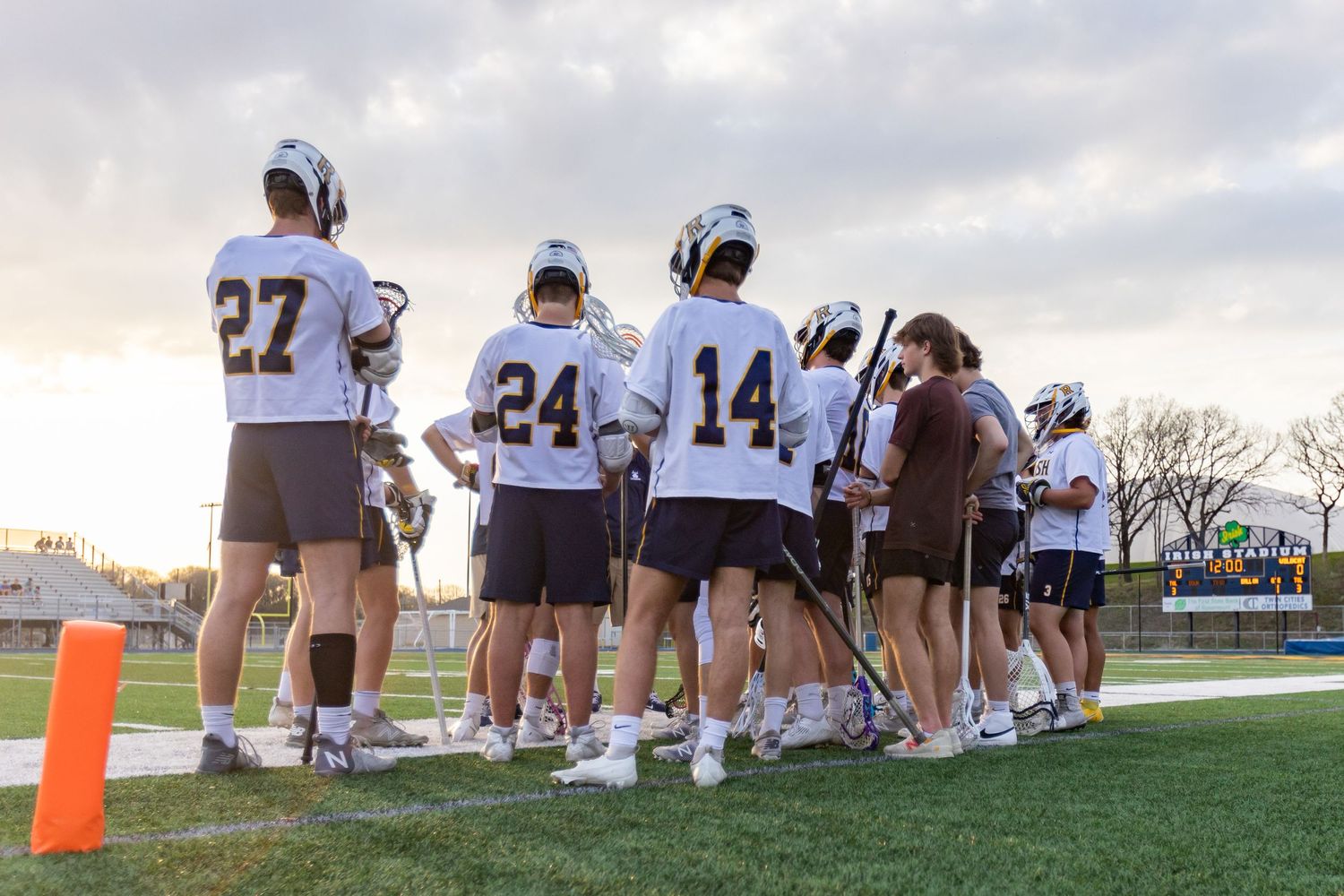 Rosemount Irish lacrosse players stand at the ready for the game to start from the sidelines