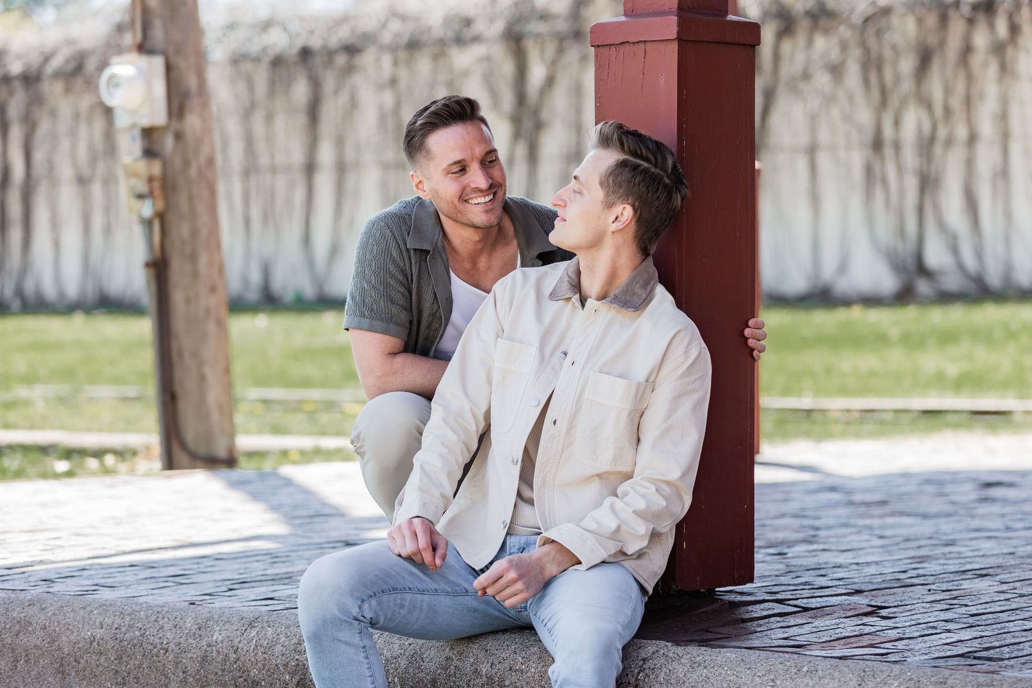 Bradley and Samuel stare lovingly at each other as they enjoy a spring morning sitting on an old train depot platform