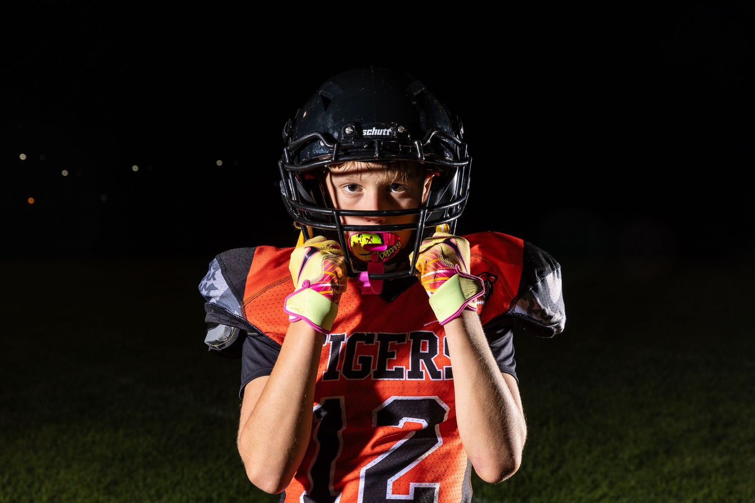 Farmington Tigers youth football player dynamic lighting sportrait twin cities sports photographer Henry Christensen