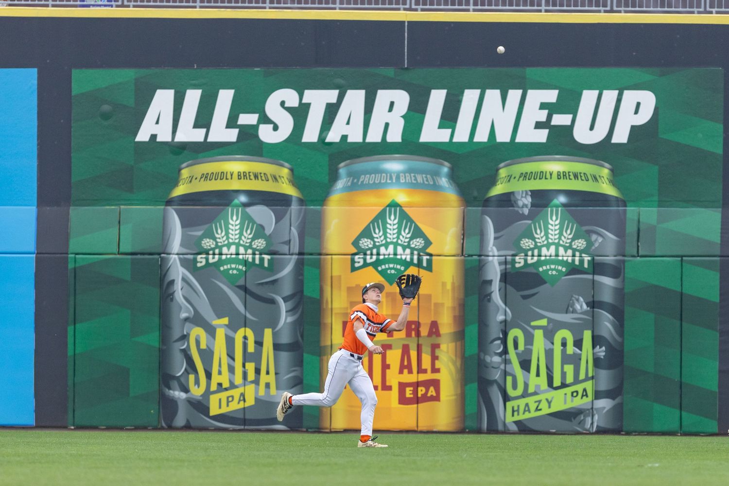 Tigers baseball player chases down a fly ball in the outfield of CHS Field