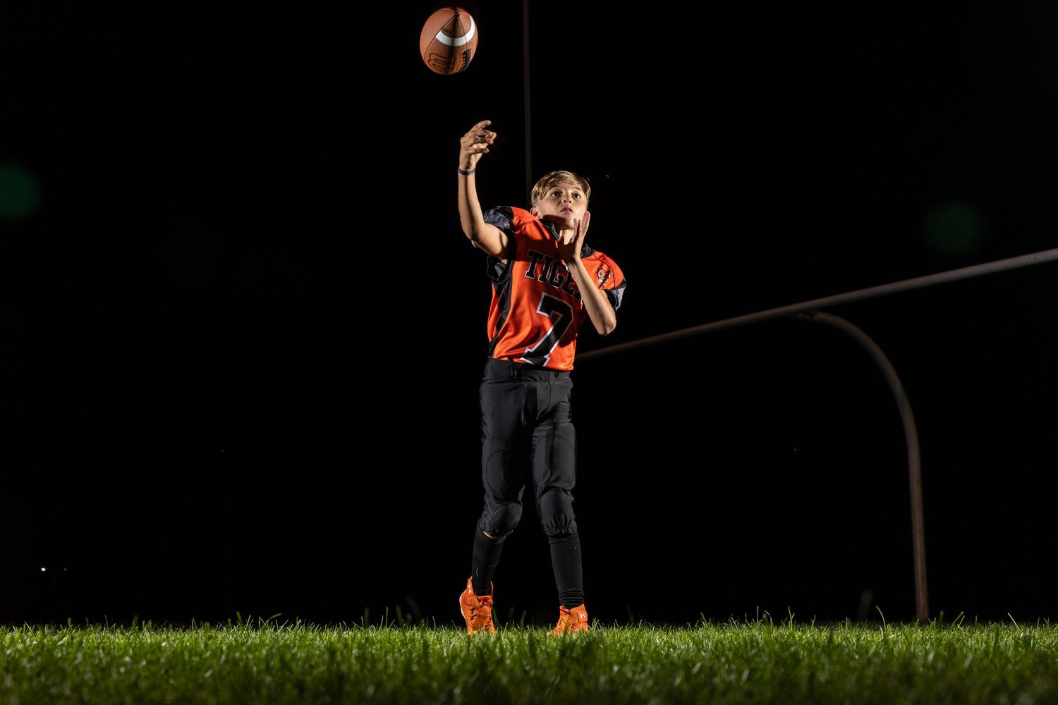 Farmington Tigers youth football player dynamic lighting sportrait twin cities sports photographer Brody Verch-Brown