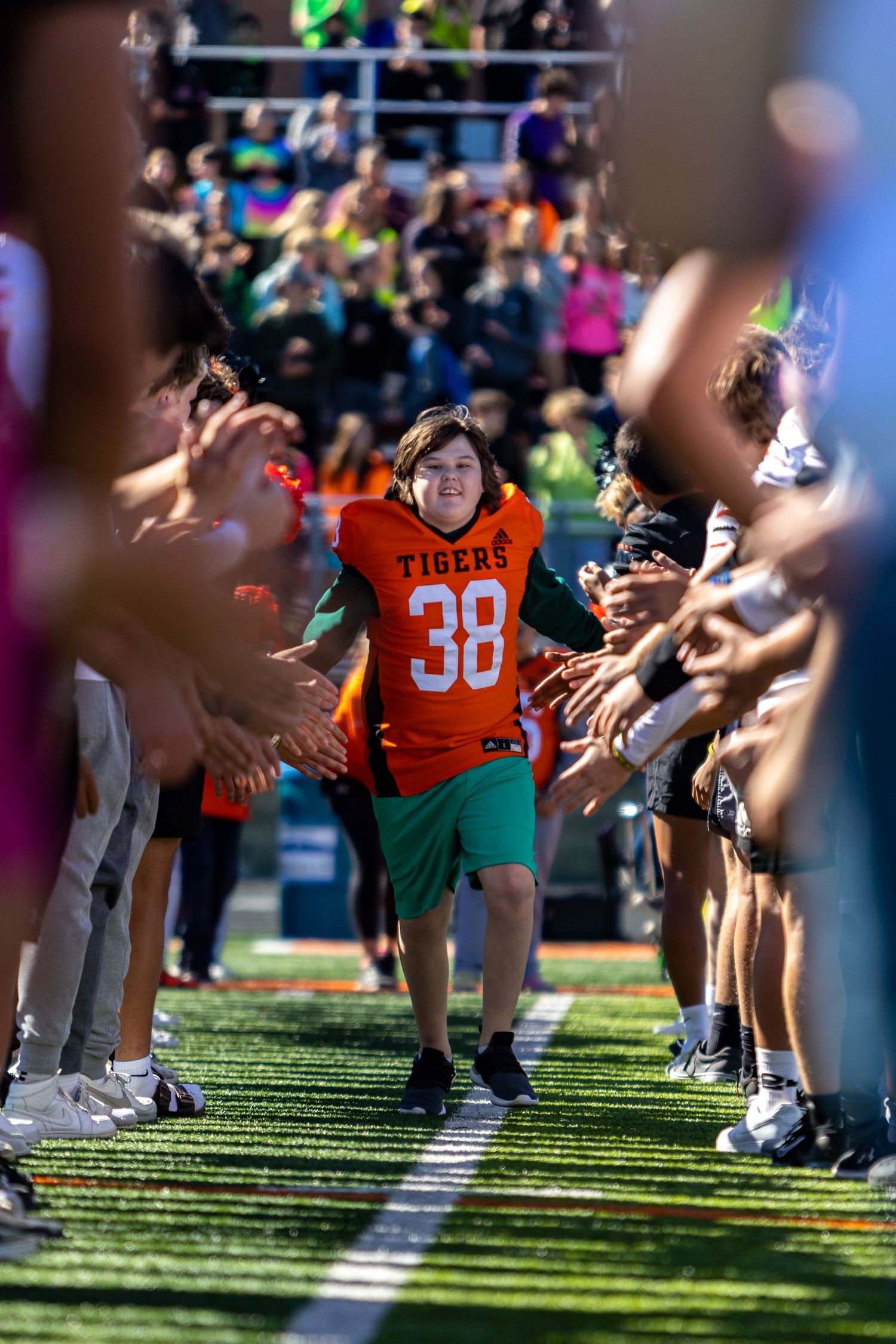 Students make the tunnel of high fives for special needs students