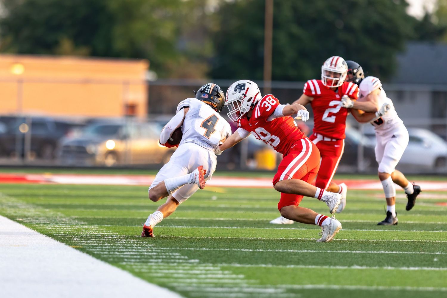 farmington tigers receiver leans into tackle against lakeville north panthers