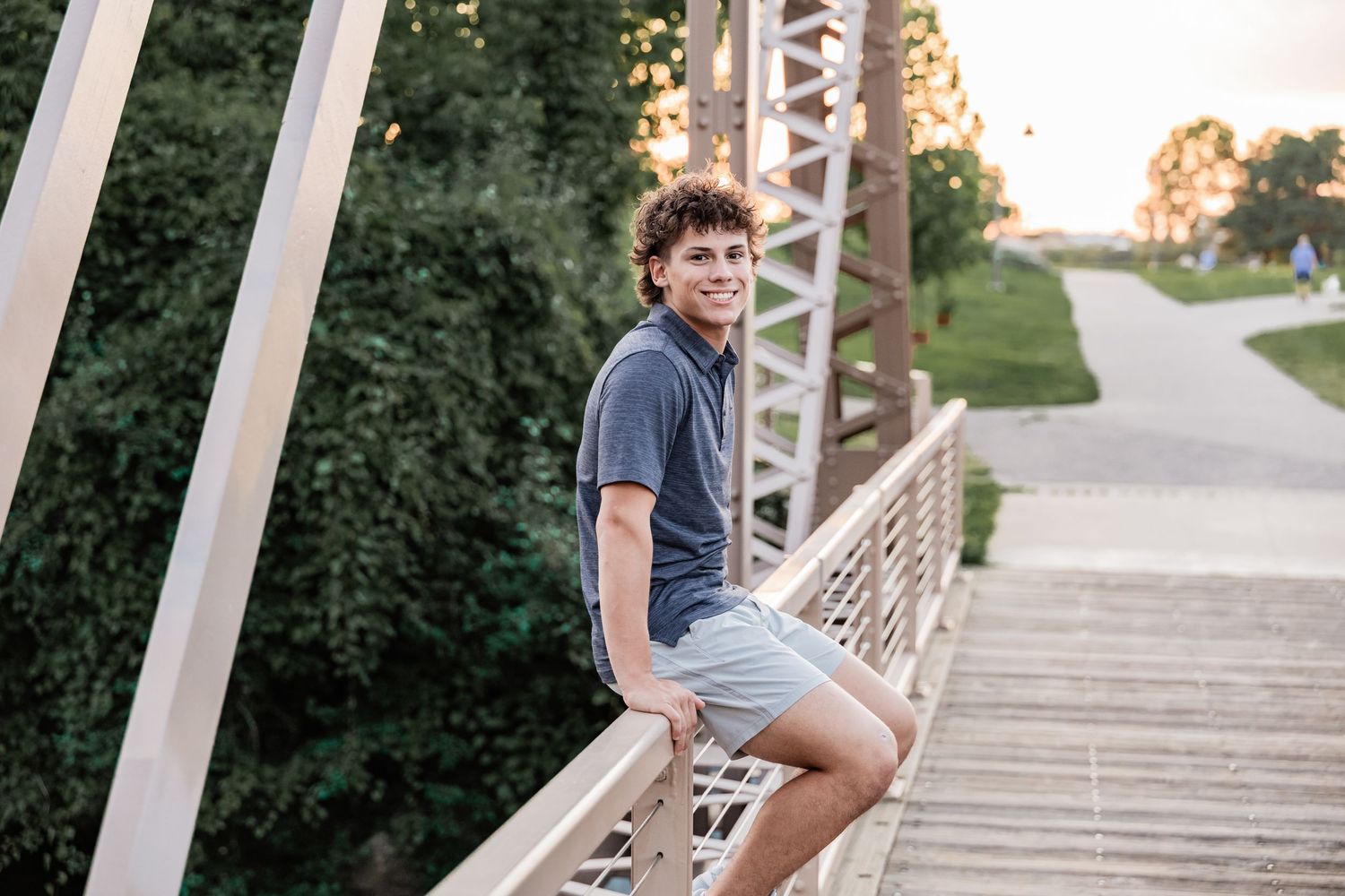 Dominic sits perched on a railing for a footbridge over the Mississippi River at Boom Island Park