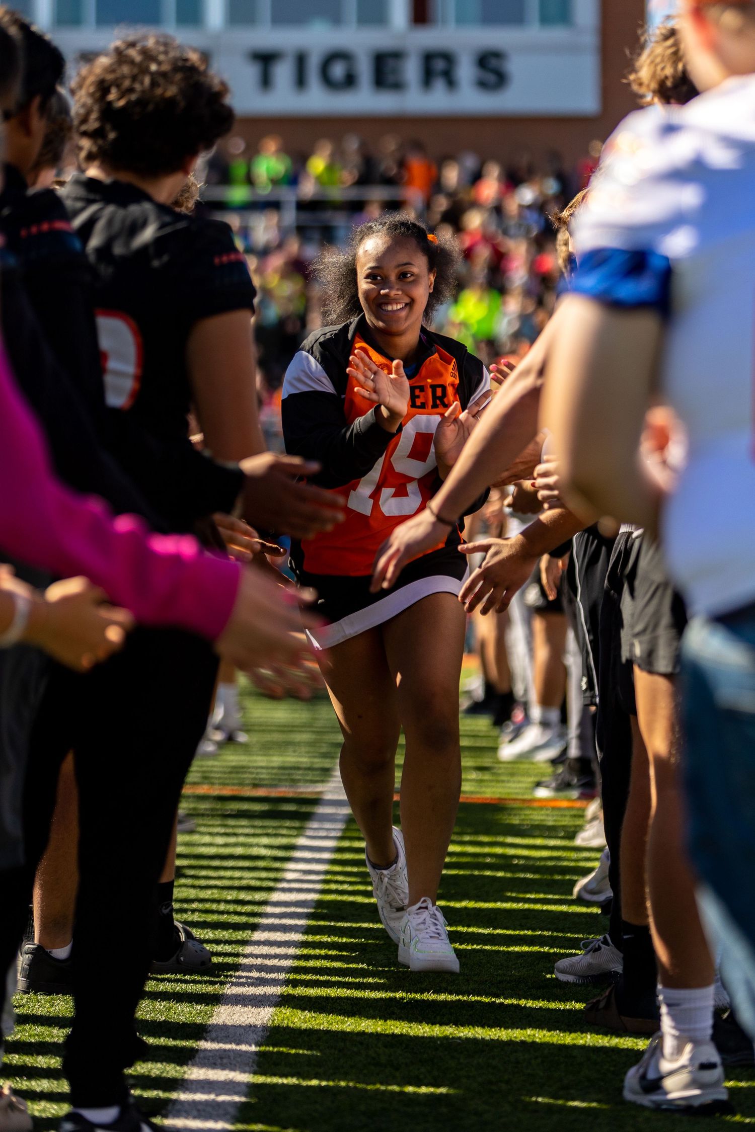 Students make the tunnel of high fives for special needs students
