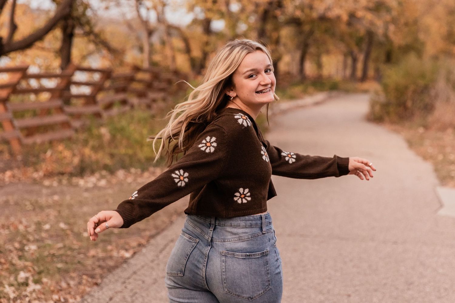 young senior girl enjoys a stroll in the fall colors