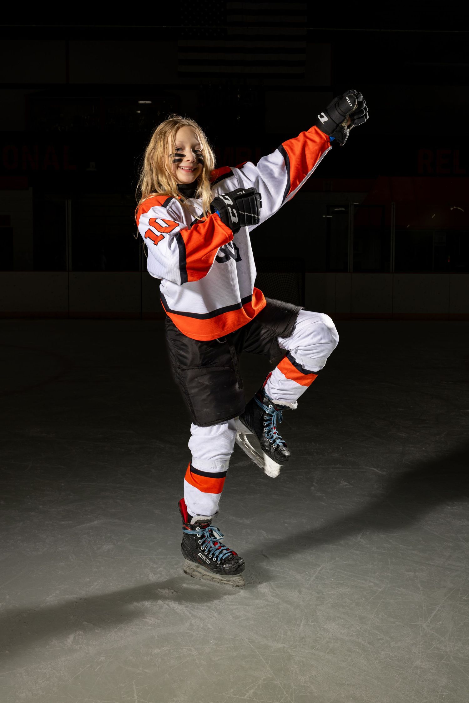 Farmington Tigers girls youth hockey player does her best archer pose for media day