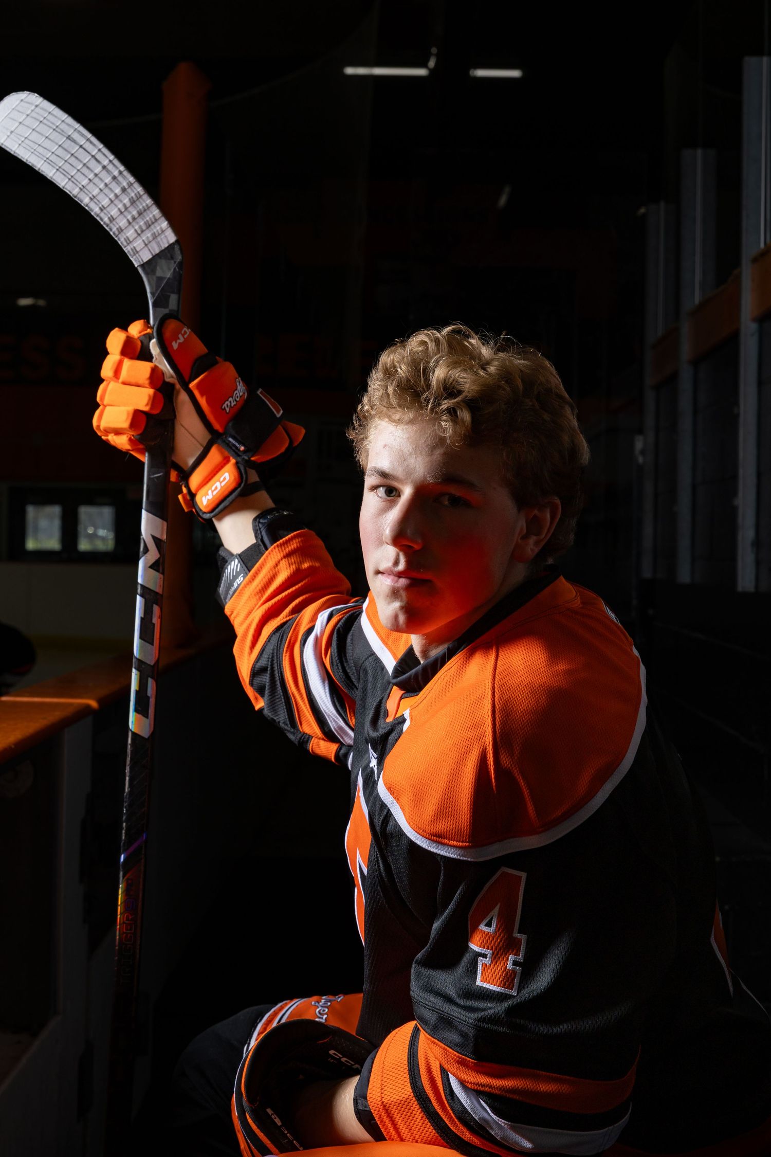 Farmington Tigers boys hockey player leans towards the camera with his game face on for media day