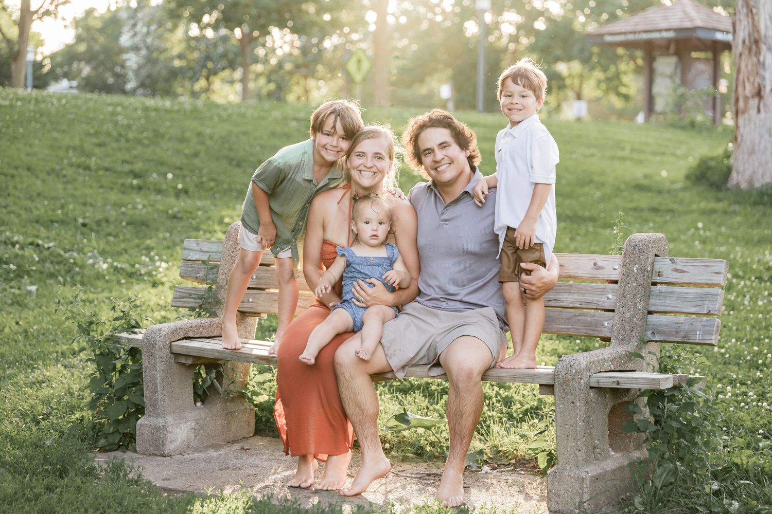 Macias family soaks up the evening sun on a wooden bench