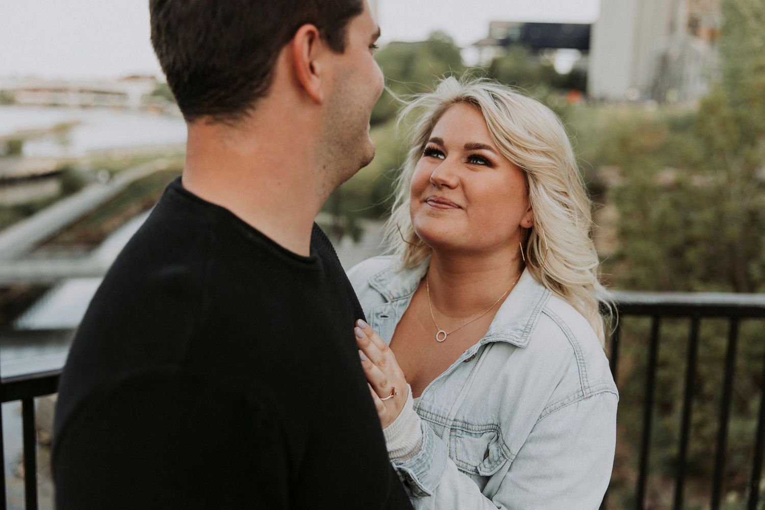 young woman gazes lovingly at her fiance during sunset