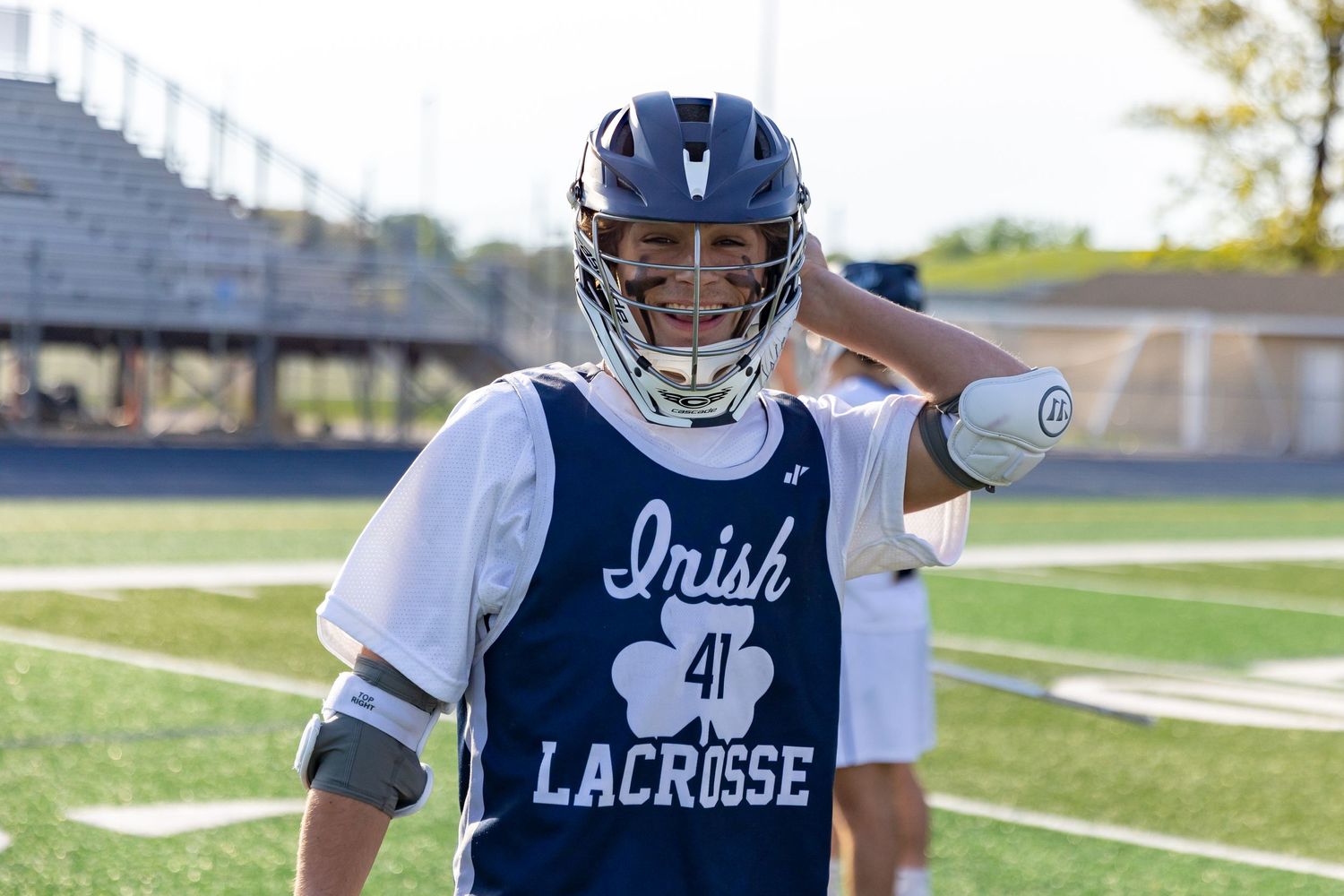 Rosemount Irish lacrosse player smiles for the camera during warmups