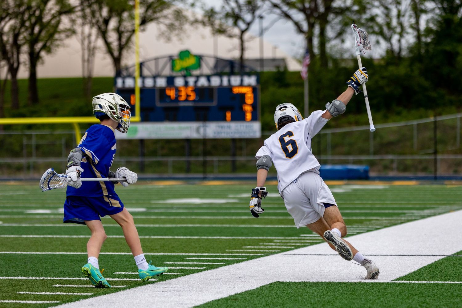 Rosemount Irish lacrosse player avoids an attacker to advance up the field