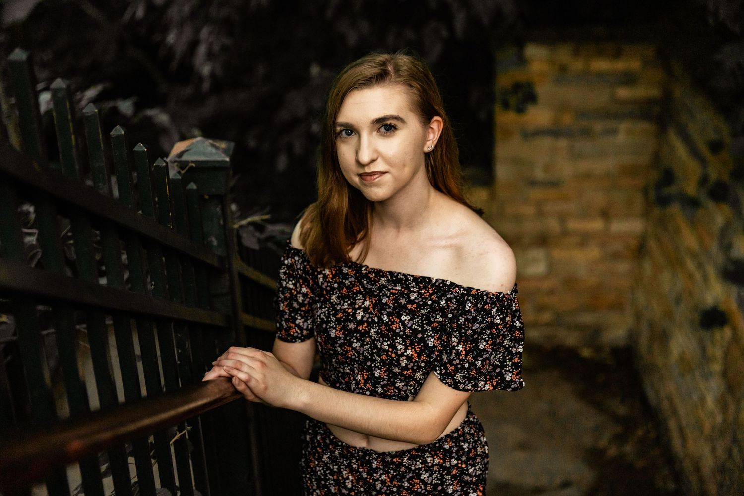 Sydney casually walks up a stone staircase with a golden glow from the sun kisses her face